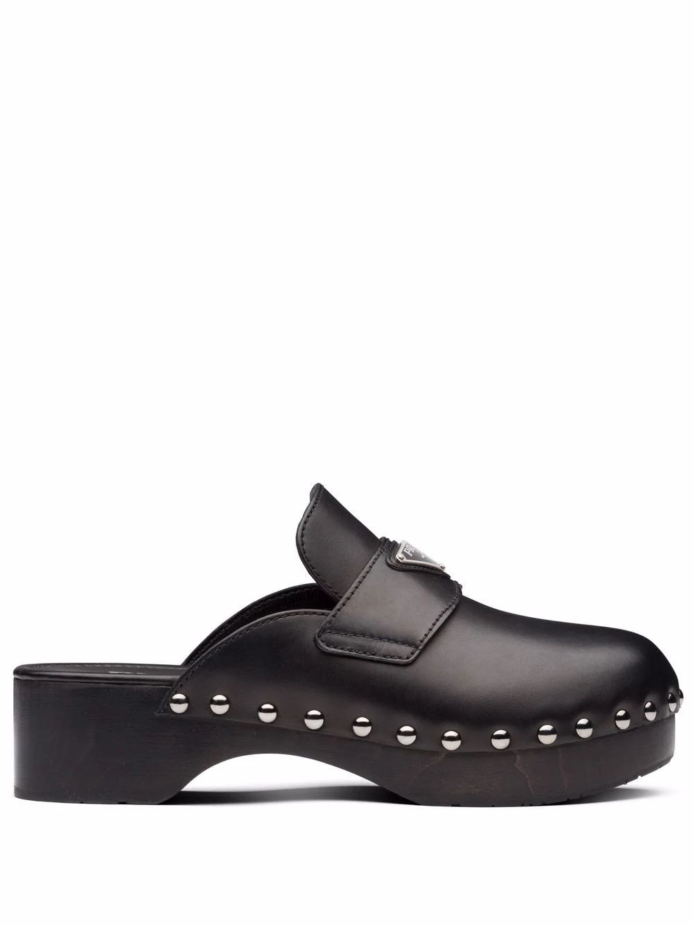 The DetailsPradatriangle logo studded clogsSet atop a wood sole and a 45mm heel, these black clog... | Farfetch Global