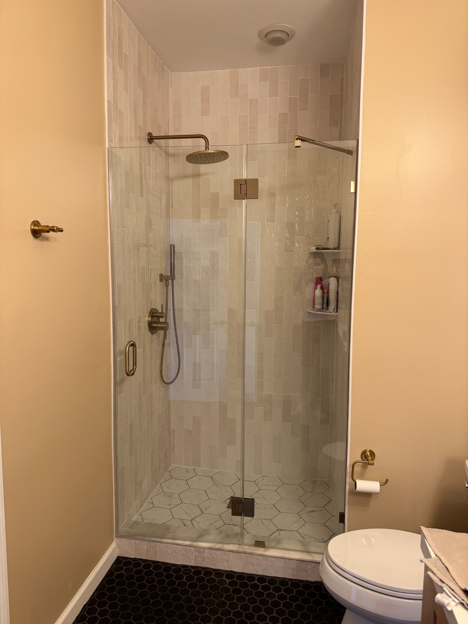 Our renovated primary bathroom is finally complete, and I couldn’t be happier with the result! We went with a double vanity from The Home Depot paired with sleek matching faucets. Above it, I added two arched mirrors outlined in black, which tie in perfectly with the vanity hardware, along with two double vanity lights for extra brightness. On the countertop, I styled a round mirror, a set of soap dispensers, and a black marble tray for a clean yet elevated look. To finish it off, we chose bold black hexagon floor tiles that really ground the space.

#LTKHome #LTKFindsUnder100