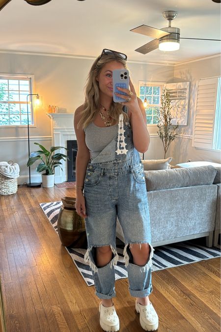 Wearing a medium in the overalls and tank top
