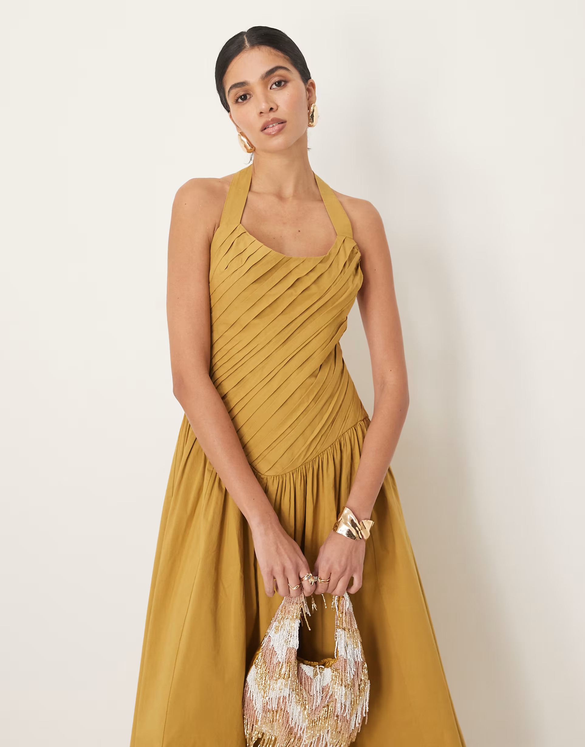 ASOS DESIGN halter neck asymmetric pleat bodice midi dress with dropped waist in turmeric | ASOS (Global)
