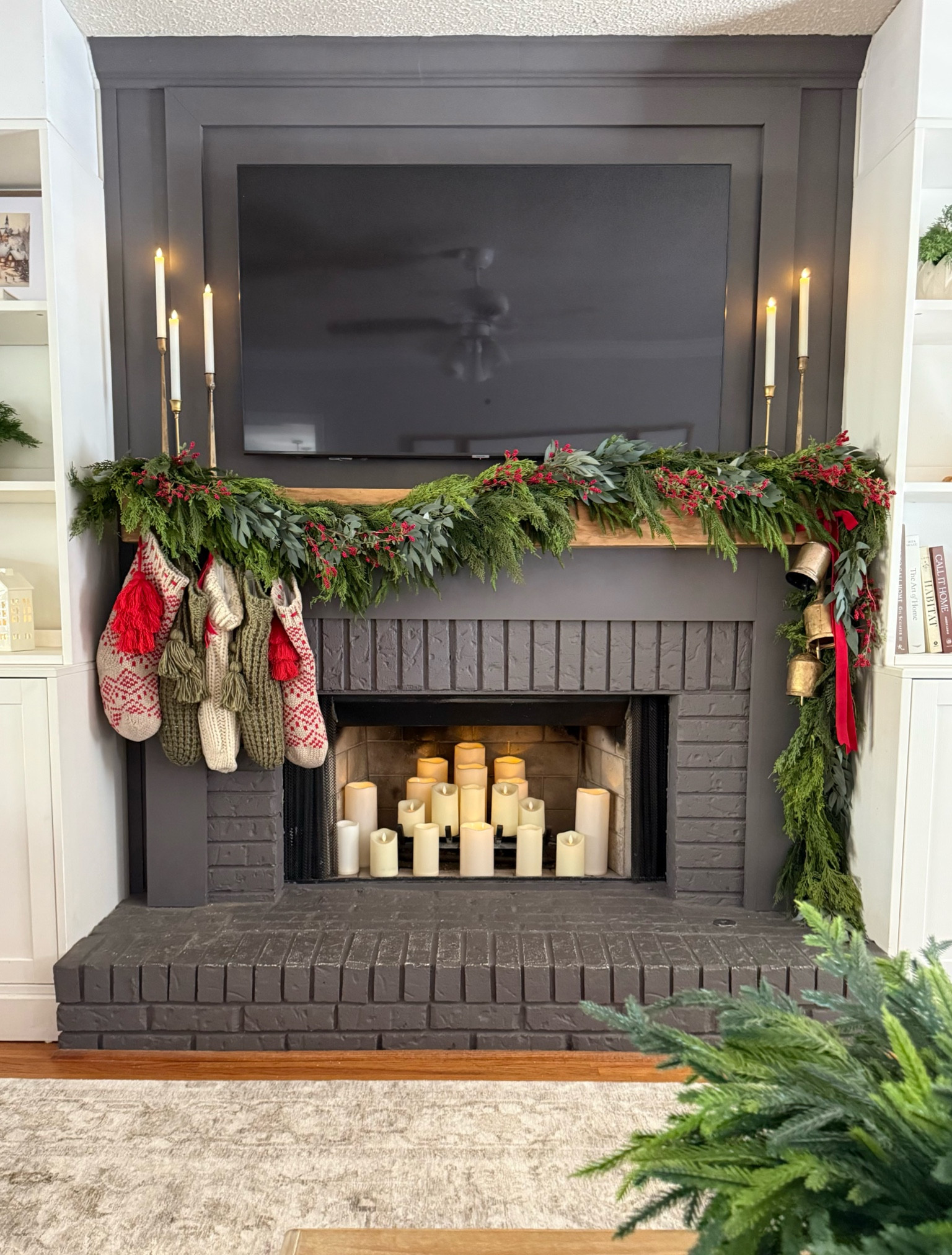 My 2024 Christmas mantle 

I used:
2- 60” Norfolk pine garlands 
2- 6 ft cedar garlands 
2- cedar/eucalyptus mix garlands 

8 single berry stems (sold in a bundle of 6)
1 strand twinkle lights 
Velvet bow
Trio of bells 
Stockings

My mantle has a rough texture, so I secure mine with nails, but have linked some command straps that are great if you have a smoother surface to apply them to. 

#LTKHome #LTKHoliday #LTKSeasonal