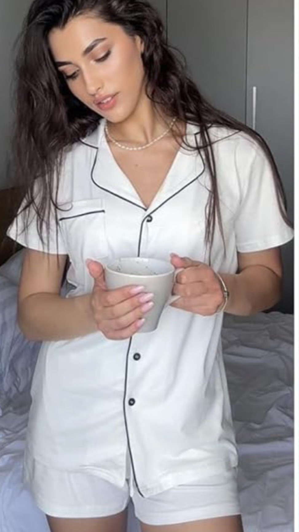 Soft button down pajama set with that cozy slow-morning feel you want at home. ☁️ Perfect for lounging, sleeping, coffee on the patio, packing for vacation, weekend mornings, bridal parties, hospital bags, or winding down after a long day when you want something comfortable but still cute. The short sleeves, button front, soft fabric, and matching two piece look make it easy to wear around the house without feeling sloppy. 

Grab this pajama set if your cozy drawer needs a fresh pair for slow mornings and quiet nights. 🌿☕️🌕

#LTKOver40 #LTKselfcare #LTKMidsize