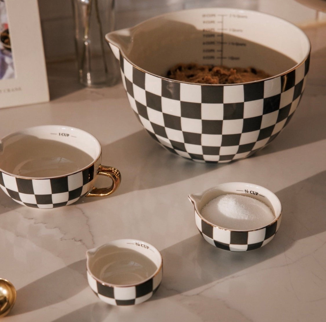 Bring order to baking and meal prep with this Thyme & Table 5-piece ceramic mixing bowl and measuring set. The set includes one 2.5 qt mixing piece and four coordinating measuring pieces, giving you a simple way to prep batters, sauces, dressings, and more. The main piece is designed with an easy-pour spout and handle, so it is easier to transfer ingredients with less mess. A nesting design helps keep the set together for compact storage, while the green checkered look adds a finished touch to your kitchen

#LTKfoodie #LTKSeasonal #LTKHome