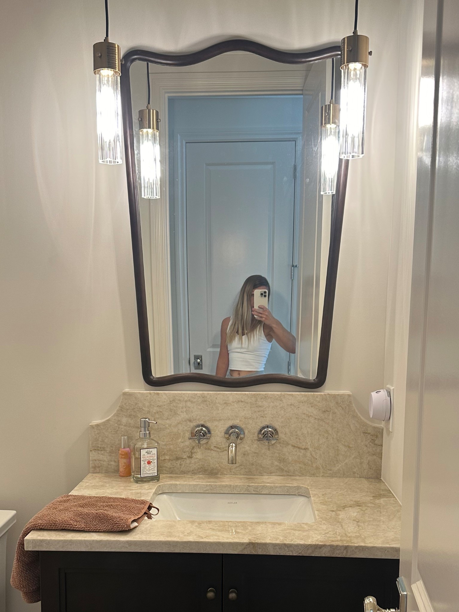 My half bath mirror and lights! 
Mirror is a dark brown wood to match vanity .
Faucet is polished nickel 
Cabinet knobs are antique bronze 

#LTKHome