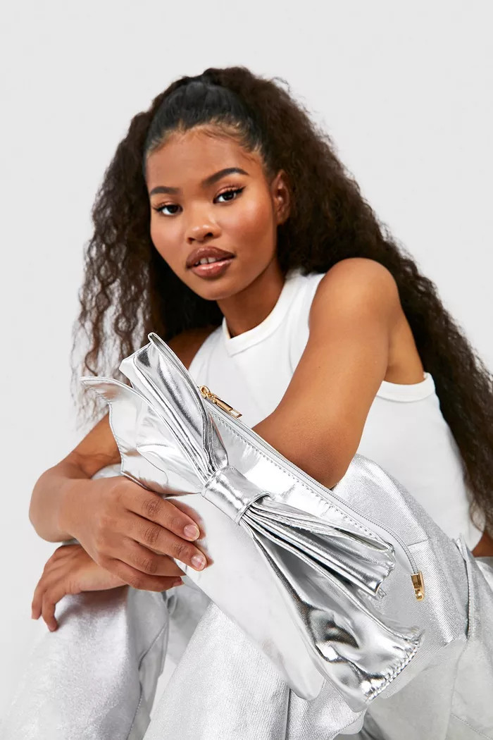 Oversized Metallic Bow Detail Clutch Bag | boohoo (US & Canada)