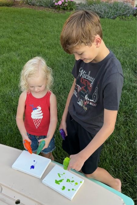 Squirt gun painting is such a fun summer activity for kids!  ☀️ 🎨 💦 This would always make a really unique birthday party activity.  🎉 Tap below to shop all the supplies!  #Summer2024 #OutdoorFun #FunInTheSun #KidsActivities 

#LTKparties #LTKfamily #LTKkids