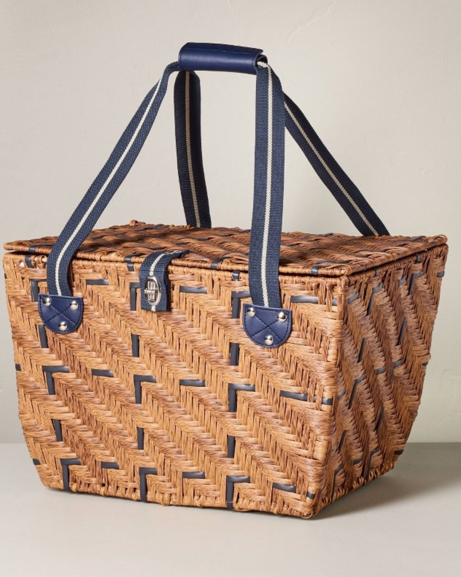 Woven Picnic Basket Light Brown
11"x16" 
*BEST SELLER*
Pack your food for the park in this Woven Picnic Basket from Hearth & Hand™ with Magnolia. Made of plastic, this picnic basket boasts a woven finish in a light-brown hue for nature-inspired charm. It features two compartments — one with a gingham lining to hold dry foods and another with foil lining and zipper closure to help keep food fresh by maintaining its temperature. It has a lid with buckle closure and also features tote handles for easy carrying.