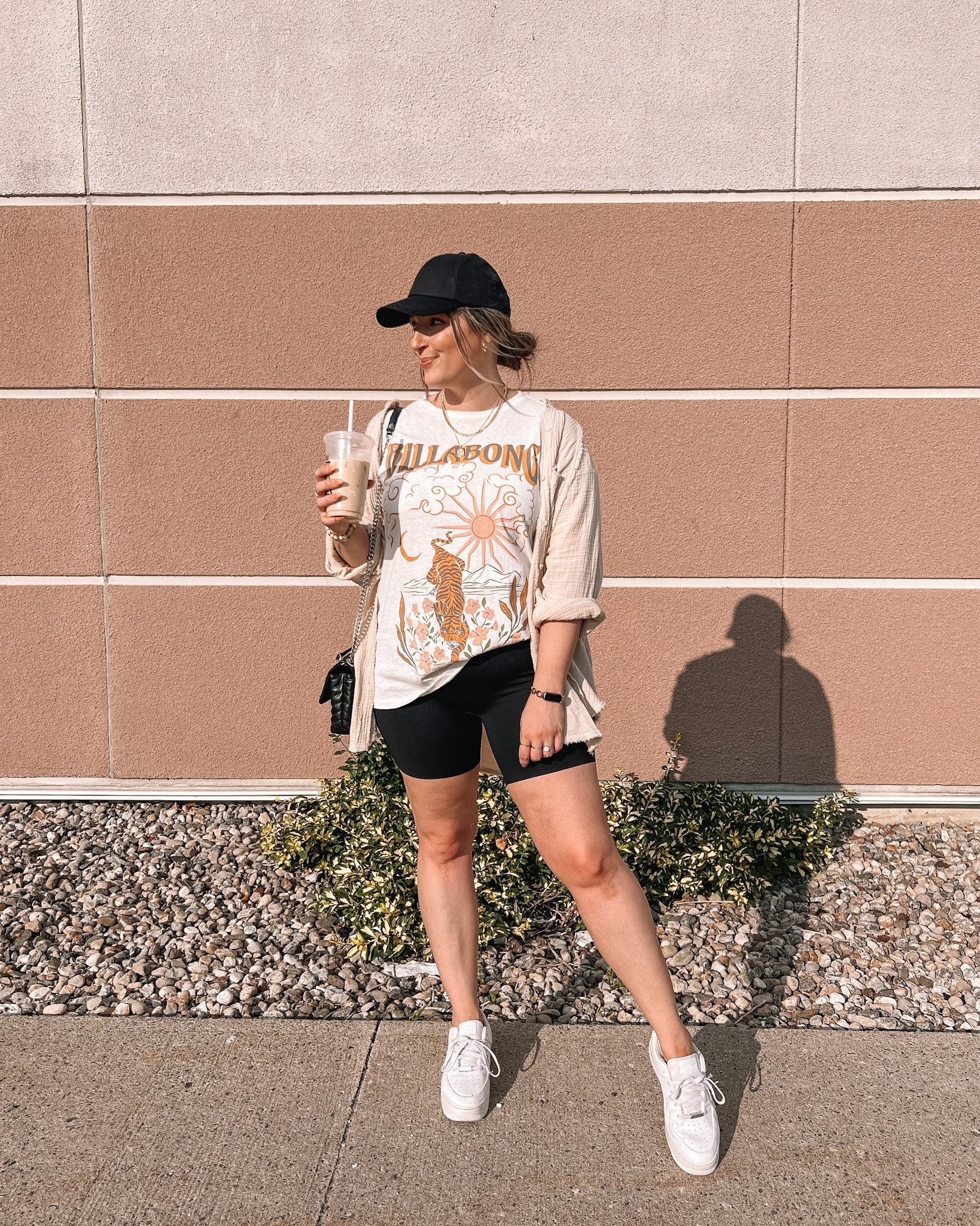 Casual comfy summer outfit - oversized graphic tee (linked similar), my fave button up shirt, seamless black biker shorts, baseball cap, white sneakers 

Midsize fashion, summer ootd


#LTKstyletip #LTKSeasonal #LTKFind
