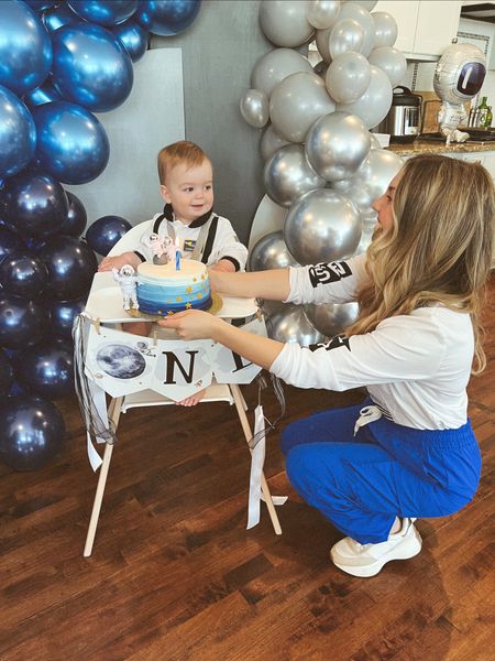 Core memory giving him his first cake!!! The balloons, the little astronaut outfit and everything was so perfect! #spacethemebirthday #1stbirthdayparty #boythemebirthday #boymom #cargopants #bluepants #astronautoutfit 

#LTKfamily #LTKbaby #LTKkids