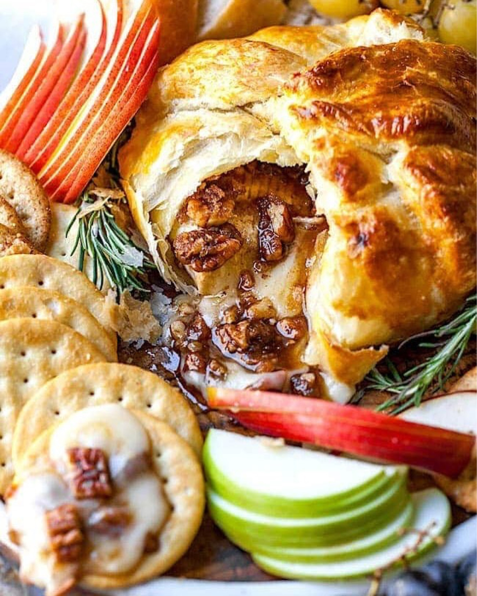 Baked Brie-brie cheese topped with pure maple syrup, brown sugar, pecans, cinnamon, and wrapped in puff pastry, and baked until golden brown. Serve the melty cheese with crackers, bread, or apple slices. Full recipe on my blog at TwoPeasAndTheirPod.com

#LTKSeasonal #LTKHome