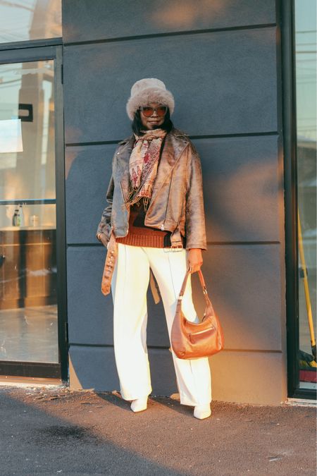 Layers 
Moto jacket, winter white pants & boots with brown sweater and fur hat 
