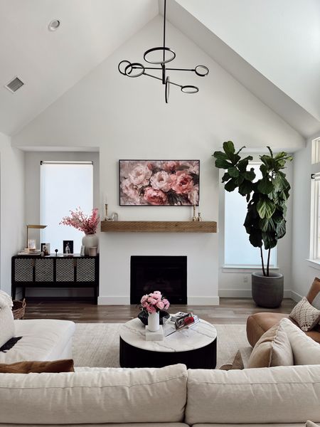 Spring refresh for our living room! Added new Samsung frame tv art with peonies. Love our transitional living room with the Arhaus Beale sectional sofa with crypton fabric, round marble coffee table, leather recliner that’s so comfortable, our fiddle leaf fig plant and living room chandelier. 

#LTKhome #LTKsalealert
