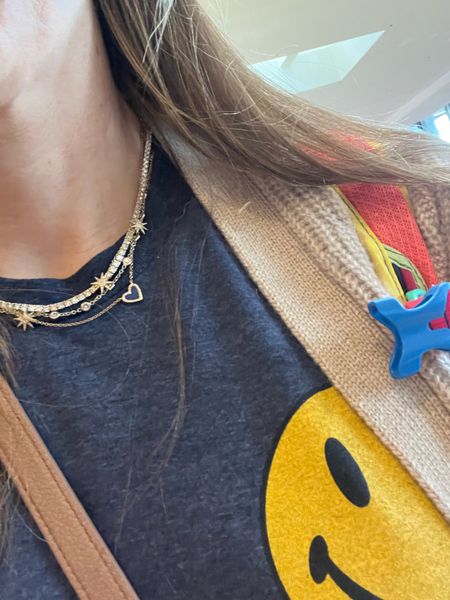 Travel outfit, smiley face tshirt, cashmere cardigan, travel carry on, mom backpack, tennis necklace, Amazon tennis necklace 

#LTKworkwear #LTKtravel #LTKFestival