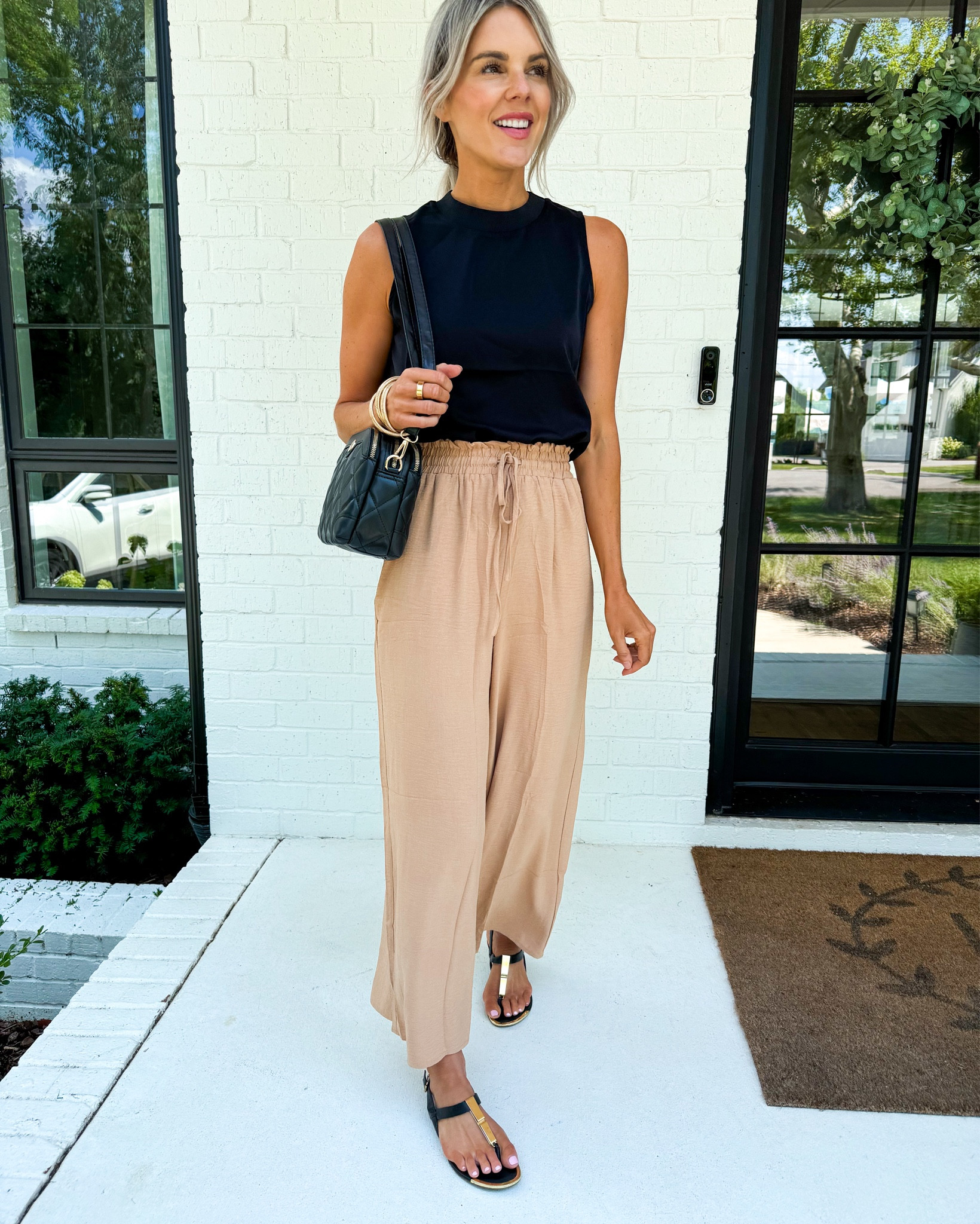 I looooooove this outfit! G this top ASAP! I know it’s hard to get excited about a basic black top, but I’m telling you you’ve got to make sure your closet is packed full of basics that you love like this top. You could easily pair it with jeans and a pair of heels and cute jewelry for a cute look or as I have it paired here with these $14 wide leg lightweight pants.

Which by the way these pants are amazing! I got them as a pair of cover-up pants for an upcoming vacation but turns out I just love them as an every day pant. Plus they’re on sale for $14.99 which is half off the normal price. I’m wearing a size small which is my normal size and they fit great. 
