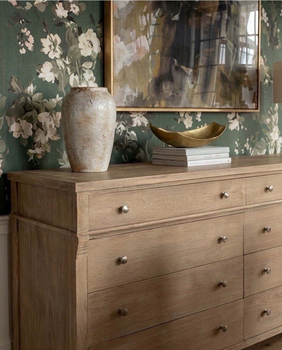 Shop the Look:
• Deep green floral wallpaper
• Marble-top dining table with fluted wood base
• Curved boucle dining chairs with brass base detail
• Light oak 6-drawer sideboard
• Matte white ceramic table lamp
• Oversized floral art in a brass frame
• Textured stone + ivory ceramic vases
• Sculptural brass decorative bowl
• Modern brass + globe chandelier
• Green vintage-style rug with cream + sage tones

#LTKSaleAlert #LTKHome