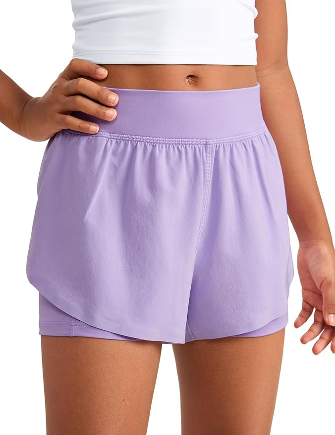 CRZ YOGA Girls 2 in 1 Dolphin Athletic Running Shorts with Pockets High Waist Teen Kid Workout Ca... | Amazon (US)