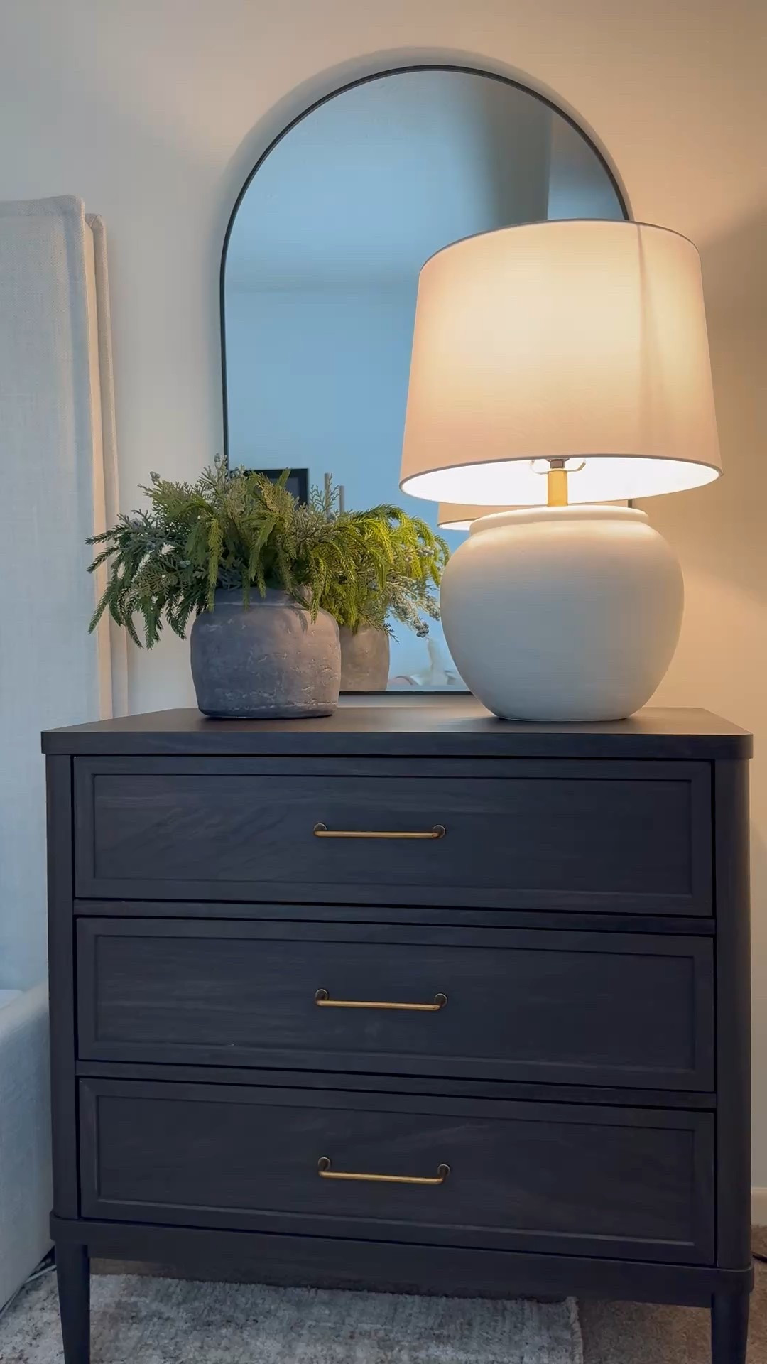 Nightstand, gray vase, clay vase, Norfolk pine stems, arch mirror, bronze handles 

#LTKSaleAlert #LTKHome #LTKSeasonal