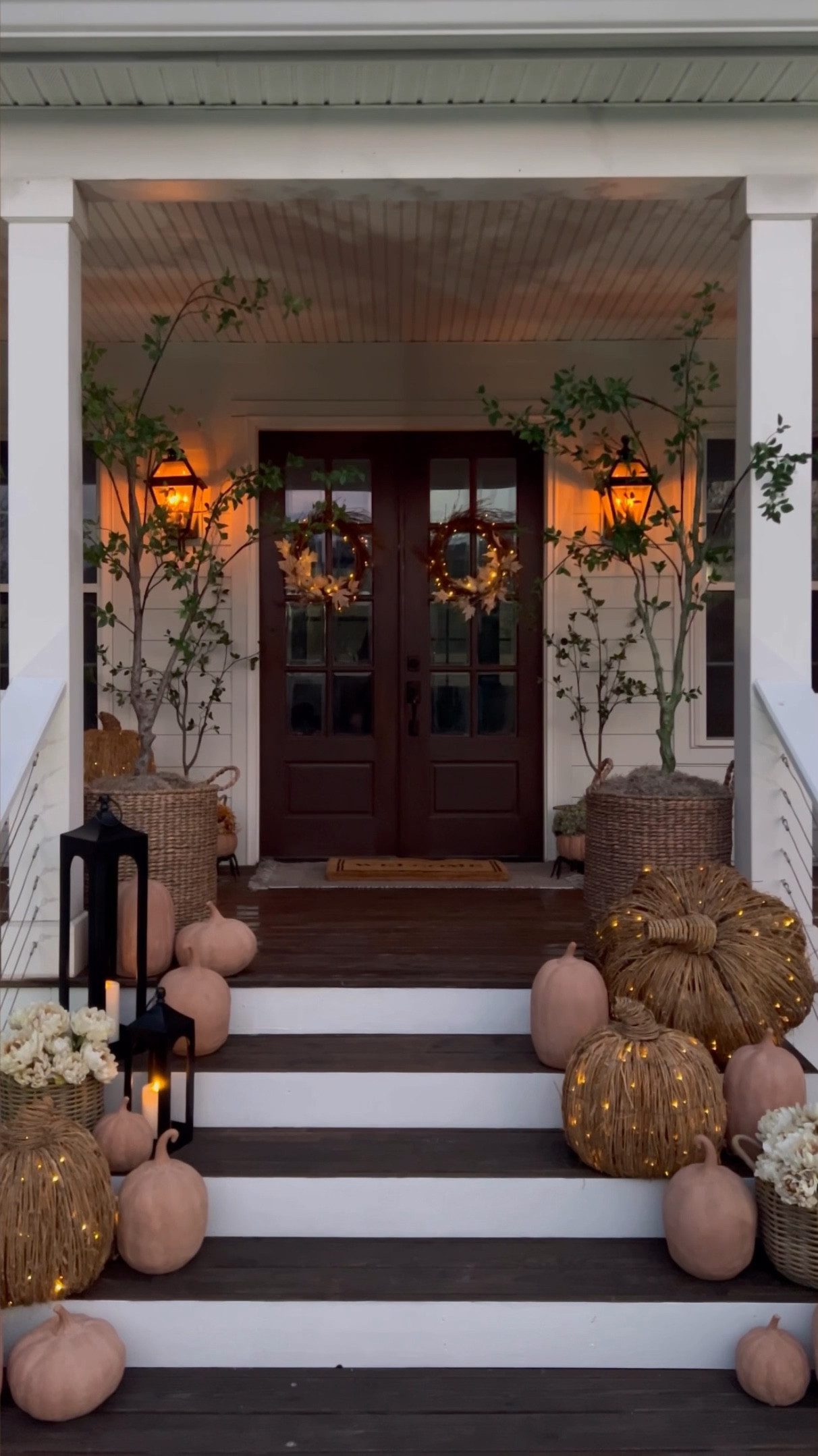 My fall porch all lit up in the evening!🤩 This is where my fairytale fall dreams really came to life with fall decorations from Pottery Barn! Step styling can be intimidating but it doesn’t have to be…here’s what I do:

1. Start with your largest pieces…the ones you want to make a statement! This was the trees and the woven pre-lit pumpkins from Pottery Barn! I spread them out for balance without making it totally symmetrical.

2. Add a few pieces with varying color and texture: the black outdoor lanterns and baskets with flowers! (These exact flowers are from Hobby Lobby)

3. Filler…the terracotta pumpkins filled in all the gaps and pulled it together! PS: I actually used several of the jack-o-lantern pumpkins so I can turn them around in a few weeks for Halloween! Stay tuned!🎃 Be sure to check out my front porch collection for more!

#LTKHalloween #LTKHome #LTKVideo