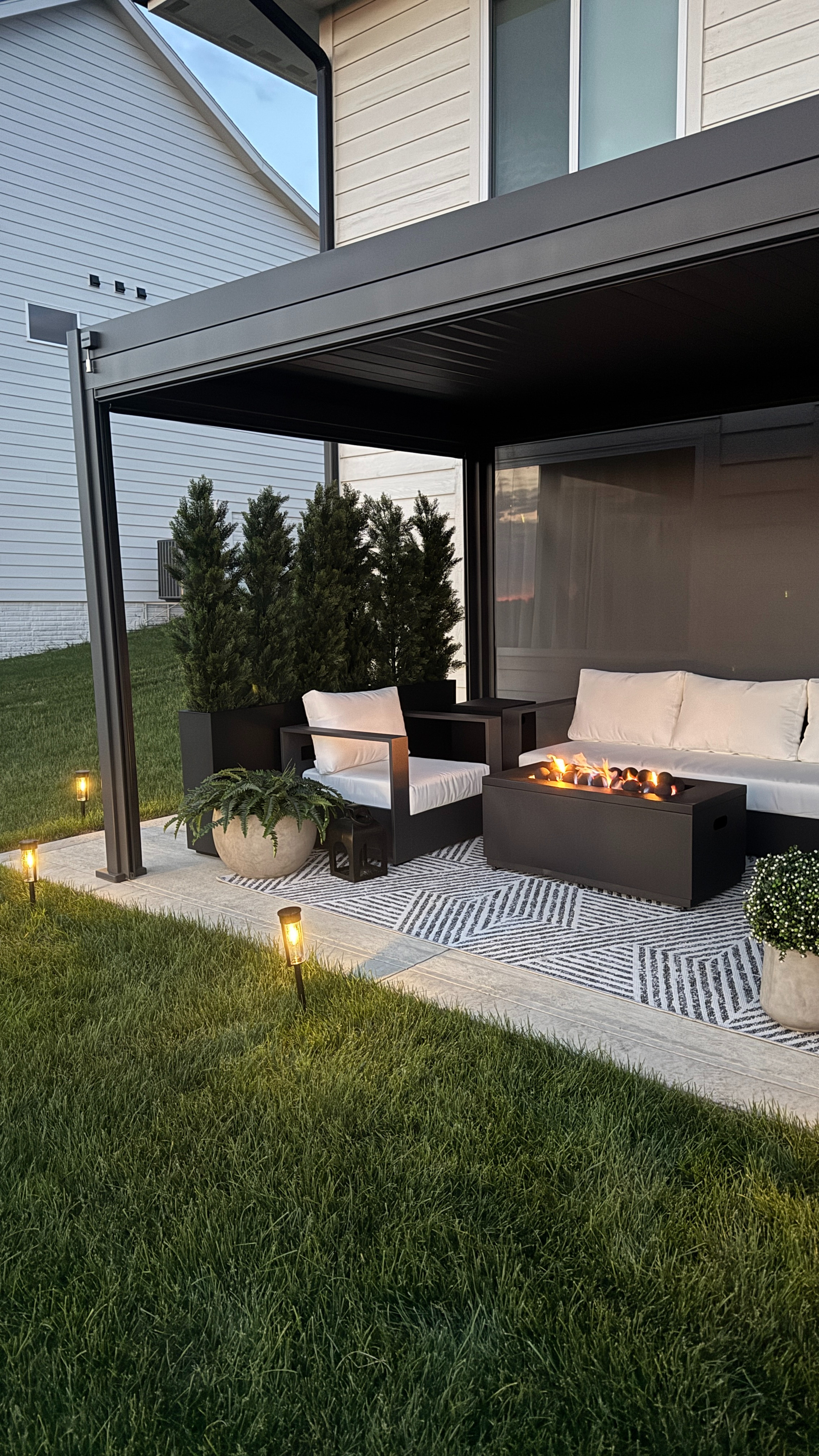 Love my outdoor patio lights  and they’re 45% off right now! 🤍 Such an easy way to make your space feel cozy at night, especially layered with patio seating, faux plants, and a fire pit table. 

 

#LTKHome #LTKSaleAlert