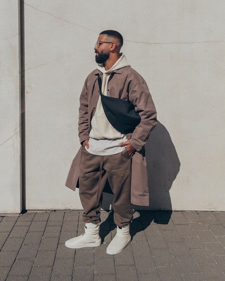 ESSENTIALS ‘Wood’ brown Long Coat (size M), ‘Egg Shell’ cream hoodie (size M), and ‘Wood’ brown sweatpants (size M). FEAR OF GOD California slides in ‘Egg Shell’ (size 41) and socks in ‘Cream'. FEAR OF GOD x BARTON PERREIRA glasses. THE ROW Black Slouchy Banana Bag. An elevated casual men’s look perfect for Fall. 

#LTKmens #LTKunder100 #LTKstyletip