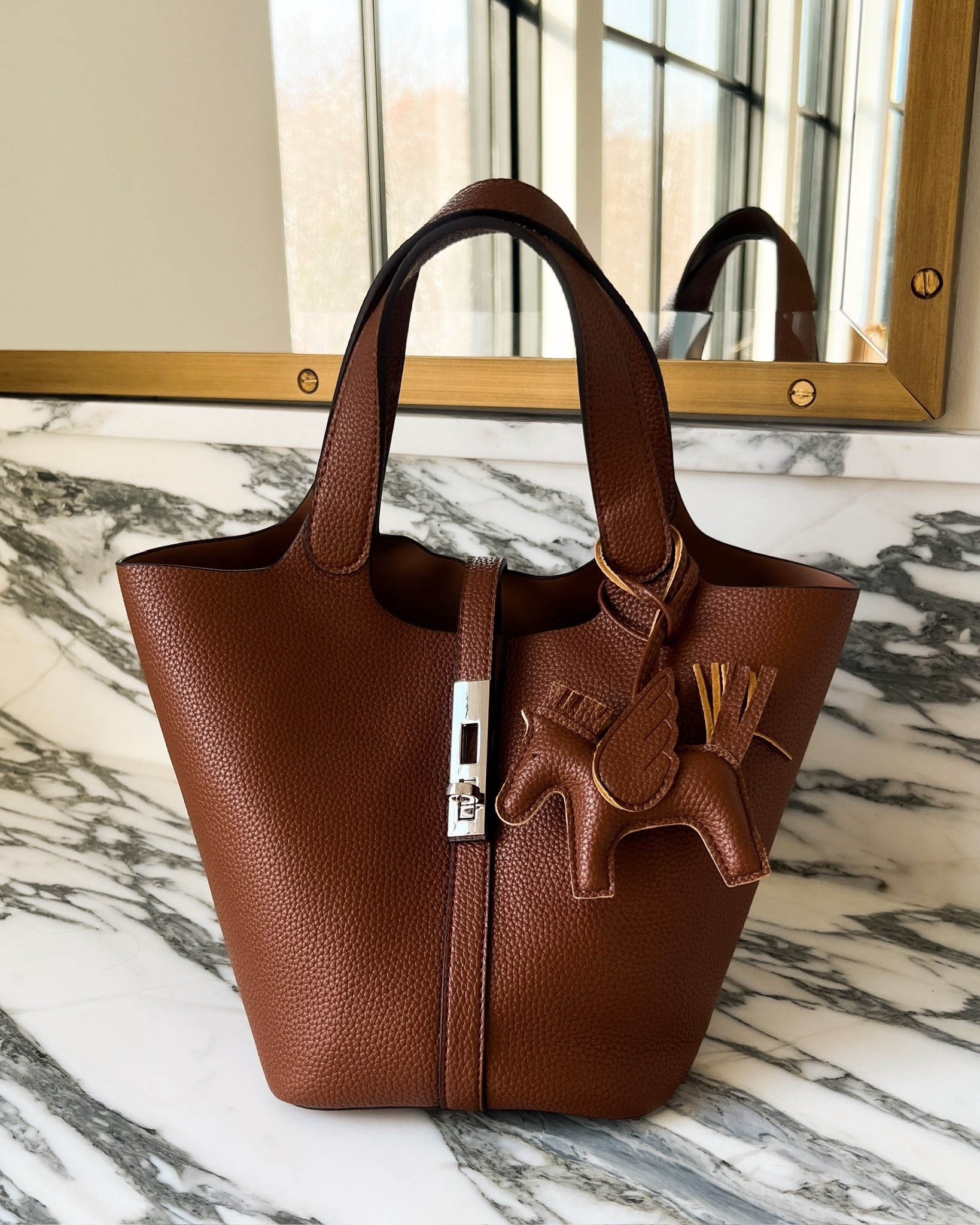 Designer-Inspired Amazon Must Have! This Amazon handbag gives that timeless structured look without the designer price tag. The rich brown tone, clean lines, and polished hardware make it feel so elevated. It fits all your everyday essentials and instantly pulls an outfit together.

Amazon Hermes Inspired Tote Bag Structured top handle design Comes in multiple colors

Miamiamine amazon handbag amazon designer inspired purse structured tote bag brown leather handbag everyday luxury look affordable designer style classic top handle bag work tote chic neutral accessories amazon favorites H inspired luxe look for less Amazon must haves

#LTKootd #LTKBeauty #LTKSeasonal