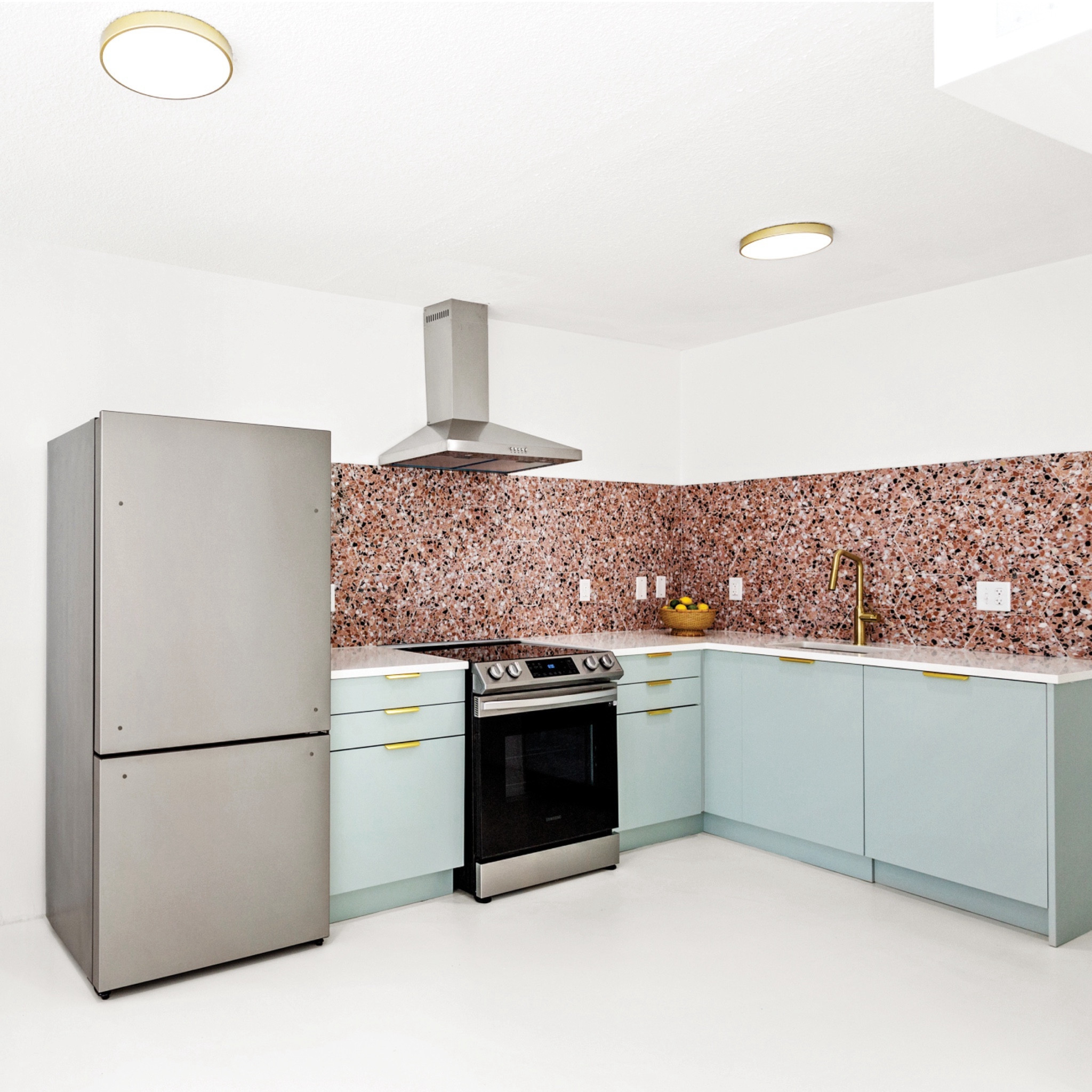the only structural change we made at the #goldengirlscondo was to open up the kitchen in order to make it feel more connected to the living space and to bring in some natural light. we had a lot of fun with the design of this space, using @semihandmade Supermatte Agave Slab cabinets, a fun terrazzo-inspired backsplash from @tilebar, gold finger pulls, and a gold faucet. #dwelloctober

#LTKhome