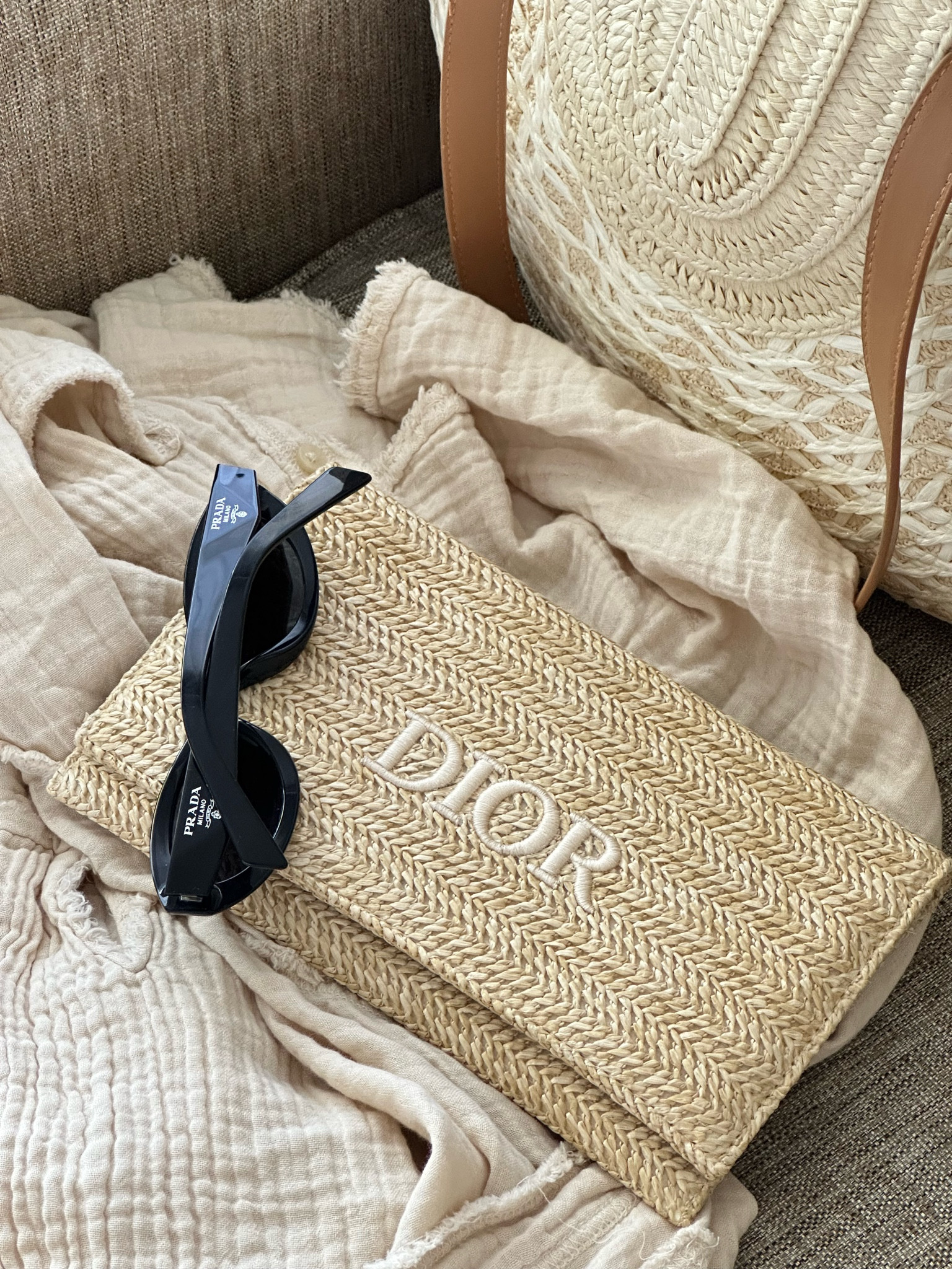 Vacation ready with beach essentials 

Prada sunglasses • Dior clutch • beach straw bag • Aerie shirt 