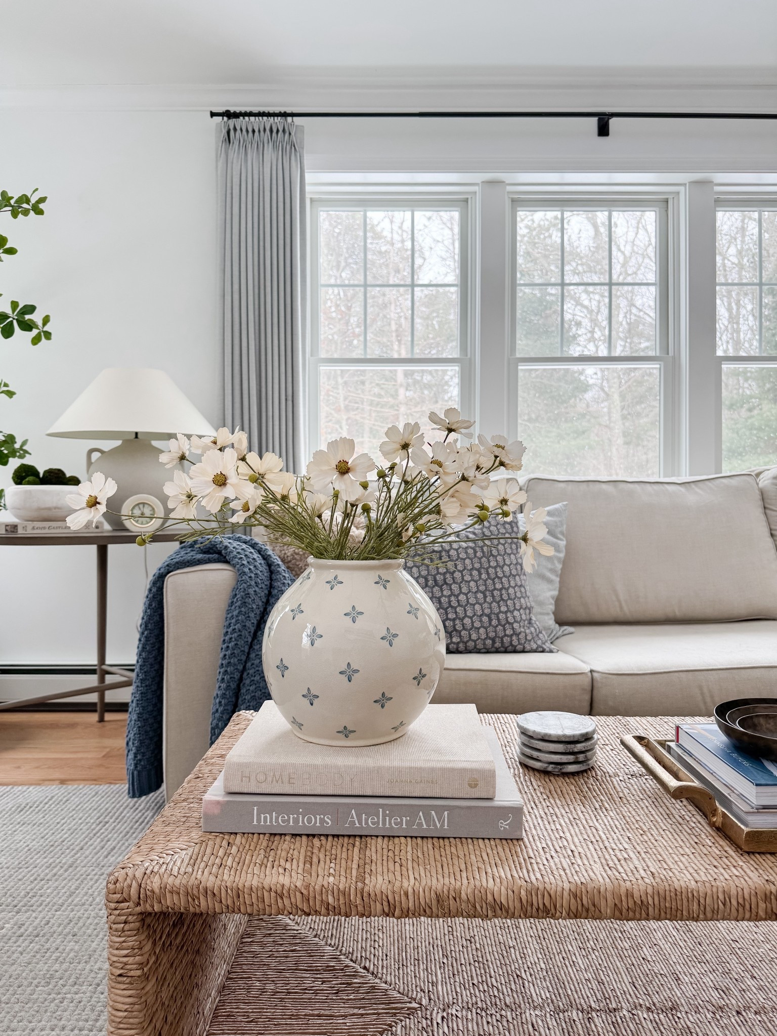 Bright neutral living room with woven coffee table, ceramic vase with greenery branches, linen drapery panels, and soft textured pillows. Natural light, organic materials, and warm wood tones bring a relaxed coastal feel. 
woven coffee table, neutral coastal decor, linen curtains, living room inspiration, spring home refresh, natural textures, ceramic vase decor, greenery stems, light filled living room, warm wood tones, coastal style, organic modern, sherri calnan home

#LTKHome