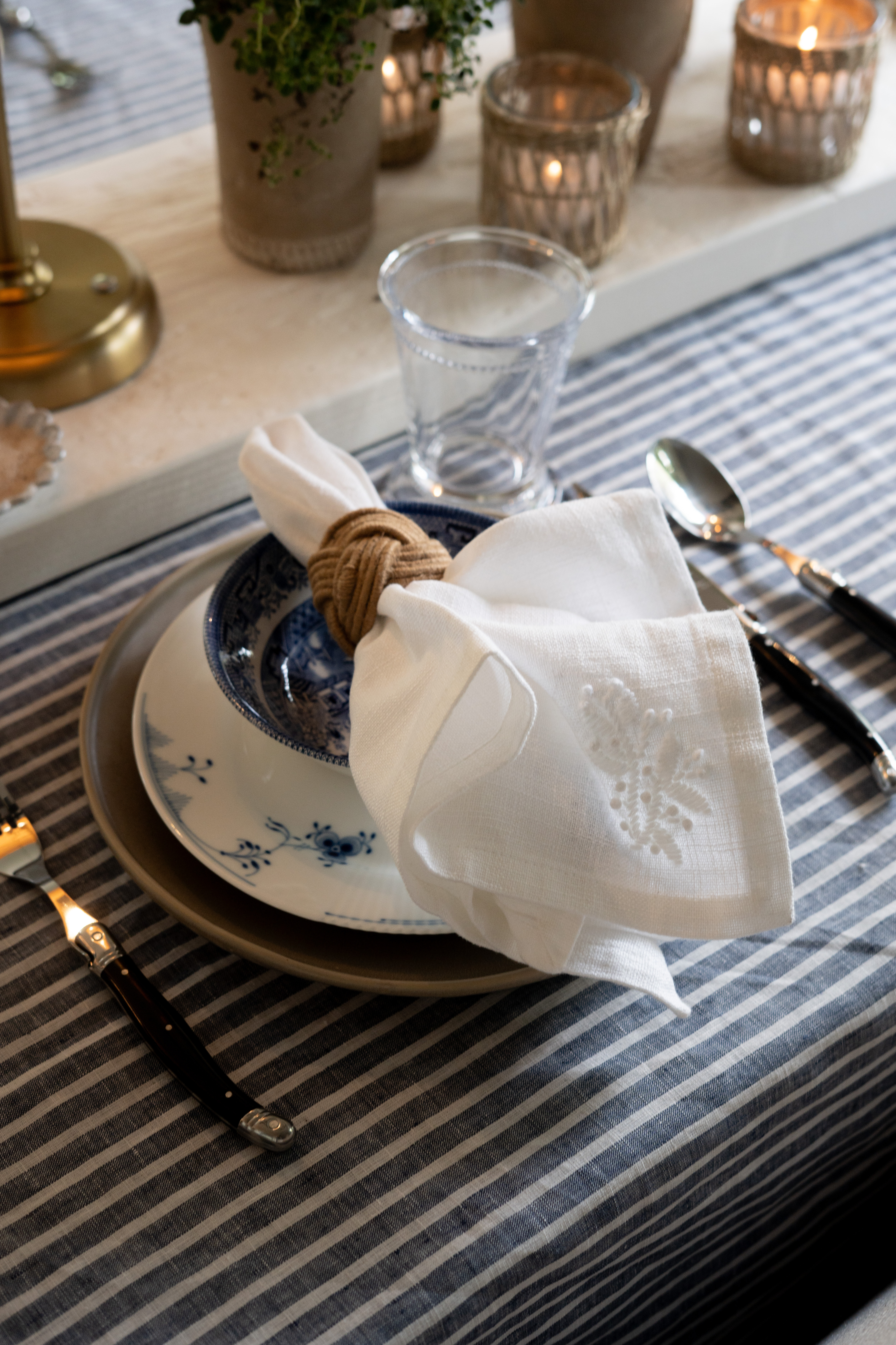 OMG I am absolutely loving this cozy, layered place setting moment! This tablescape brings together blue and white dinnerware, linen napkins, and warm candlelight for an effortless, elevated everyday look. I always say small styling details like napkin rings and textures make the biggest impact in creating a beautiful, inviting home! It's sooo perfect for spring!  

 #LTKSeasonal #LTKOver40 #LTKHome