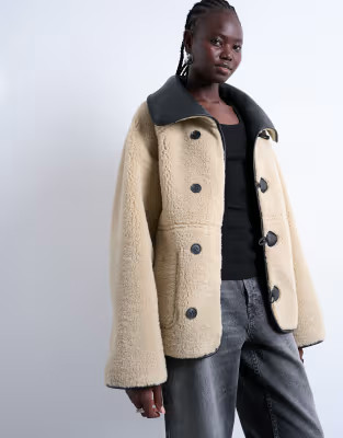 Topshop shearling oversized reversible coat with button loop in black and cream | ASOS (Global)