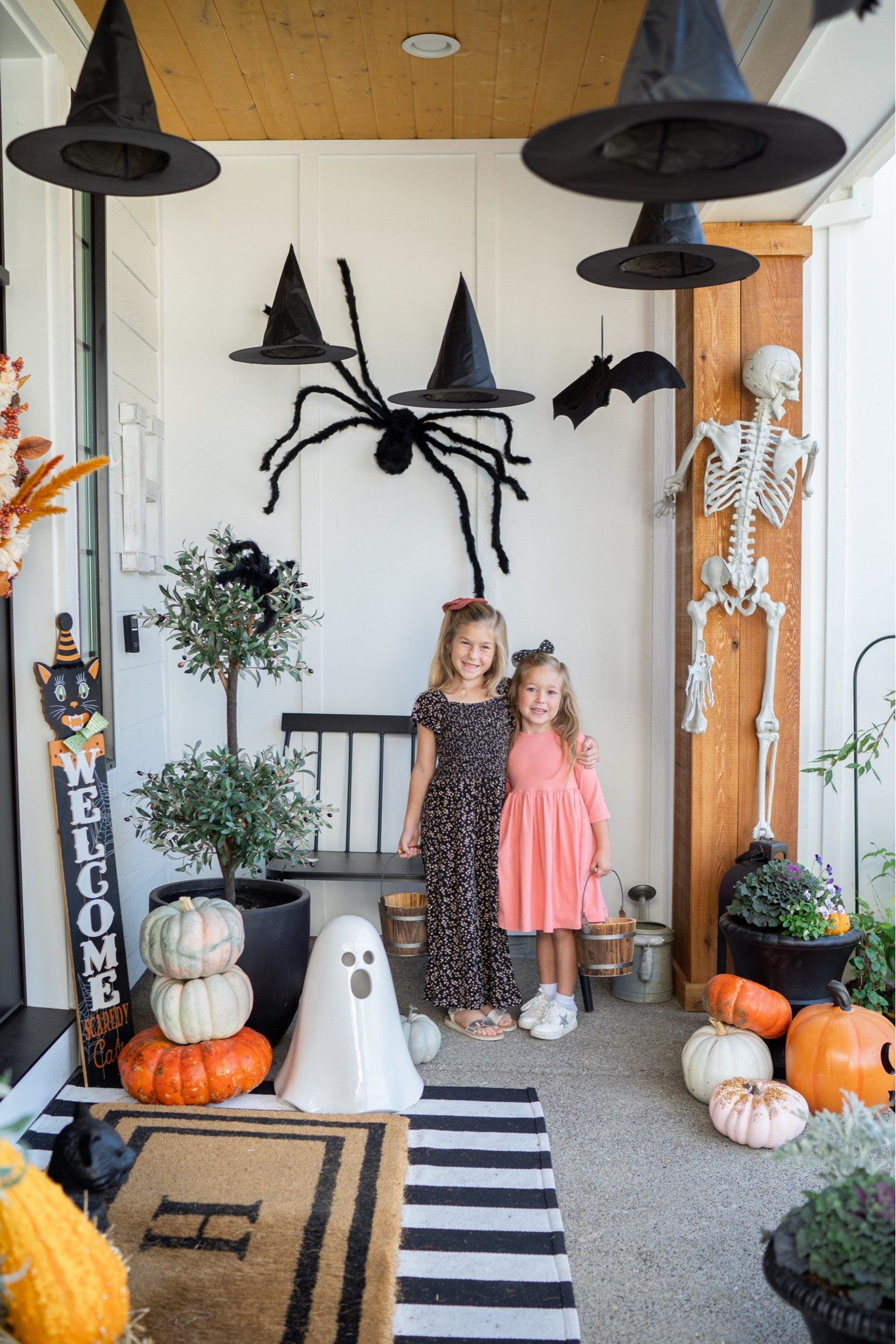 Halloween porch decor! We love these hanging witch hats, skeletons and the touches of orange! 

#LTKSeasonal #LTKhome #LTKstyletip