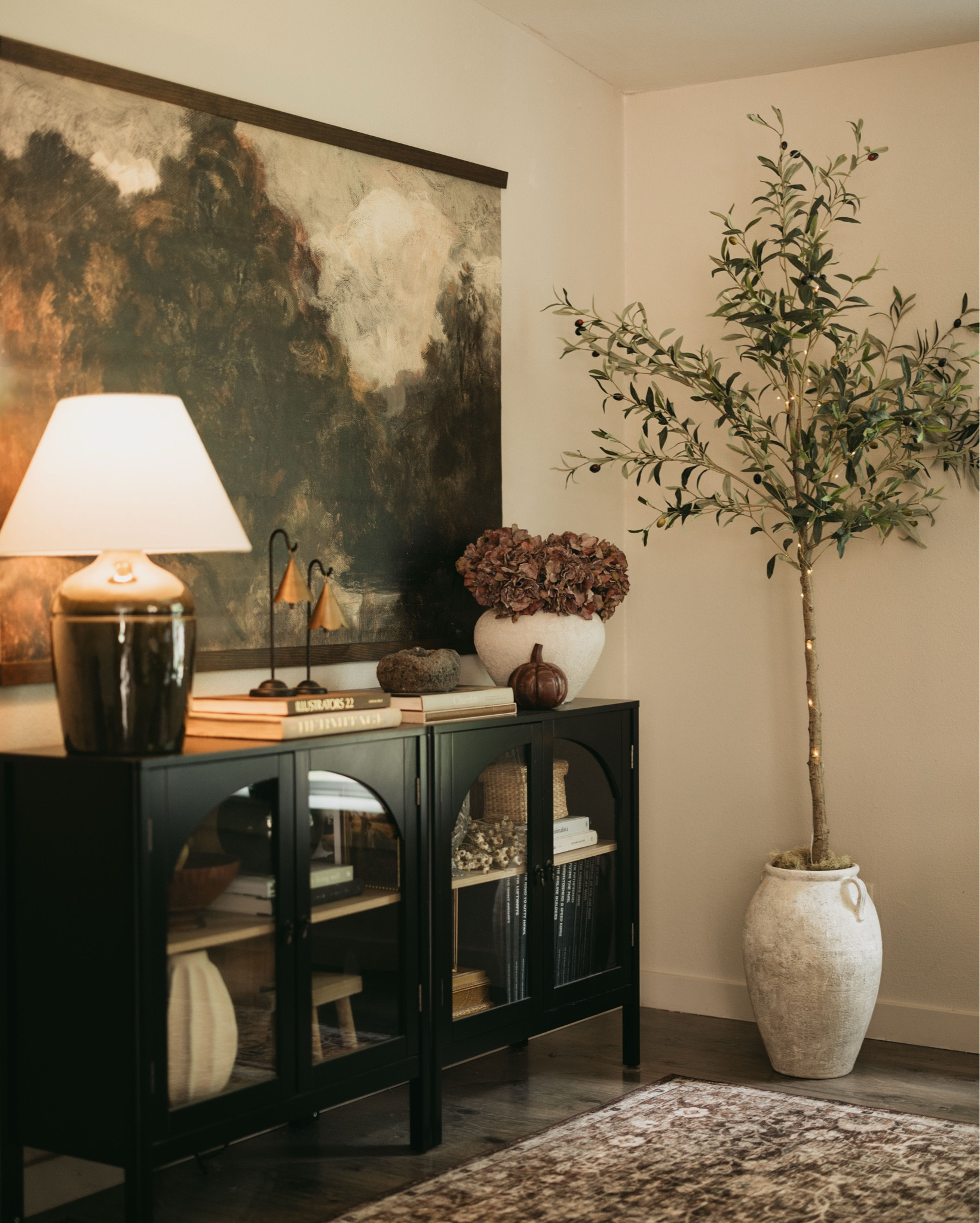 Cozy corners are my love language 🤍✨ Layered textures, stacked books, moody art, and a touch of greenery make this space feel collected + calm. 

#LTKHome #LTKStyleTip #LTKSeasonal