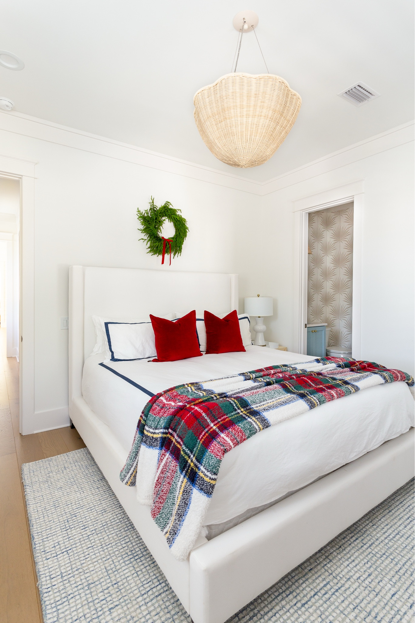 Our Christmas guest bedroom includes red velvet pillows, a plush Stewart plaid blanket, faux greenery stems, a wreath with a red bow and more. Also including links to our white upholstered bed (as well as a look for less), tall wood dresser, rattan bench, palm wallpaper, scalloped wicker chandelier, blue grid rug, and hotel style bedding. See our full Christmas home tour here: https://lifeonvirginiastreet.com/2024-christmas-home-tour/ #ltkholiday #ltkhome #ltksalealert #ltkfindsunder50 #ltkfindsunder100 #ltkstyletip #ltkseasonal 

#LTKHome #LTKHoliday #LTKSaleAlert