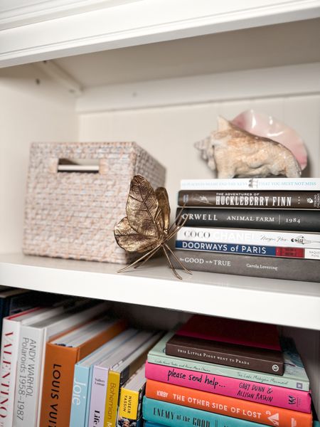Bookshelf decor spring shelf styling with golden decorative butterfly decor and shell 
