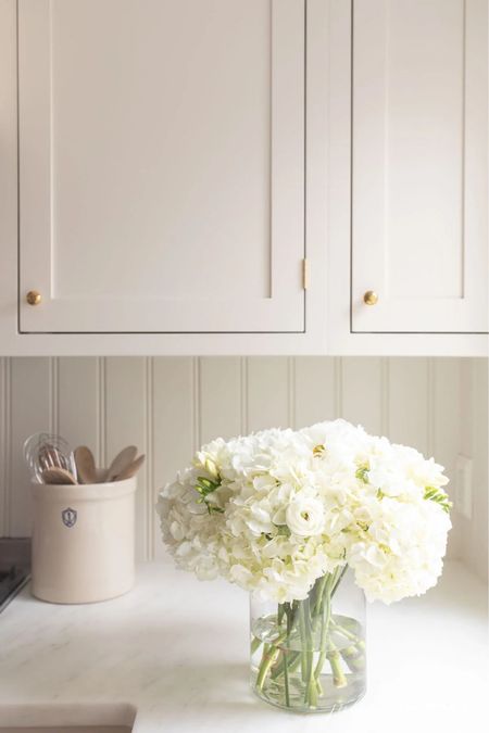 Pretty kitchen countertop with a charming crock to hold utensils and a pretty hydrangea arrangement  


#LTKstyletip #LTKhome