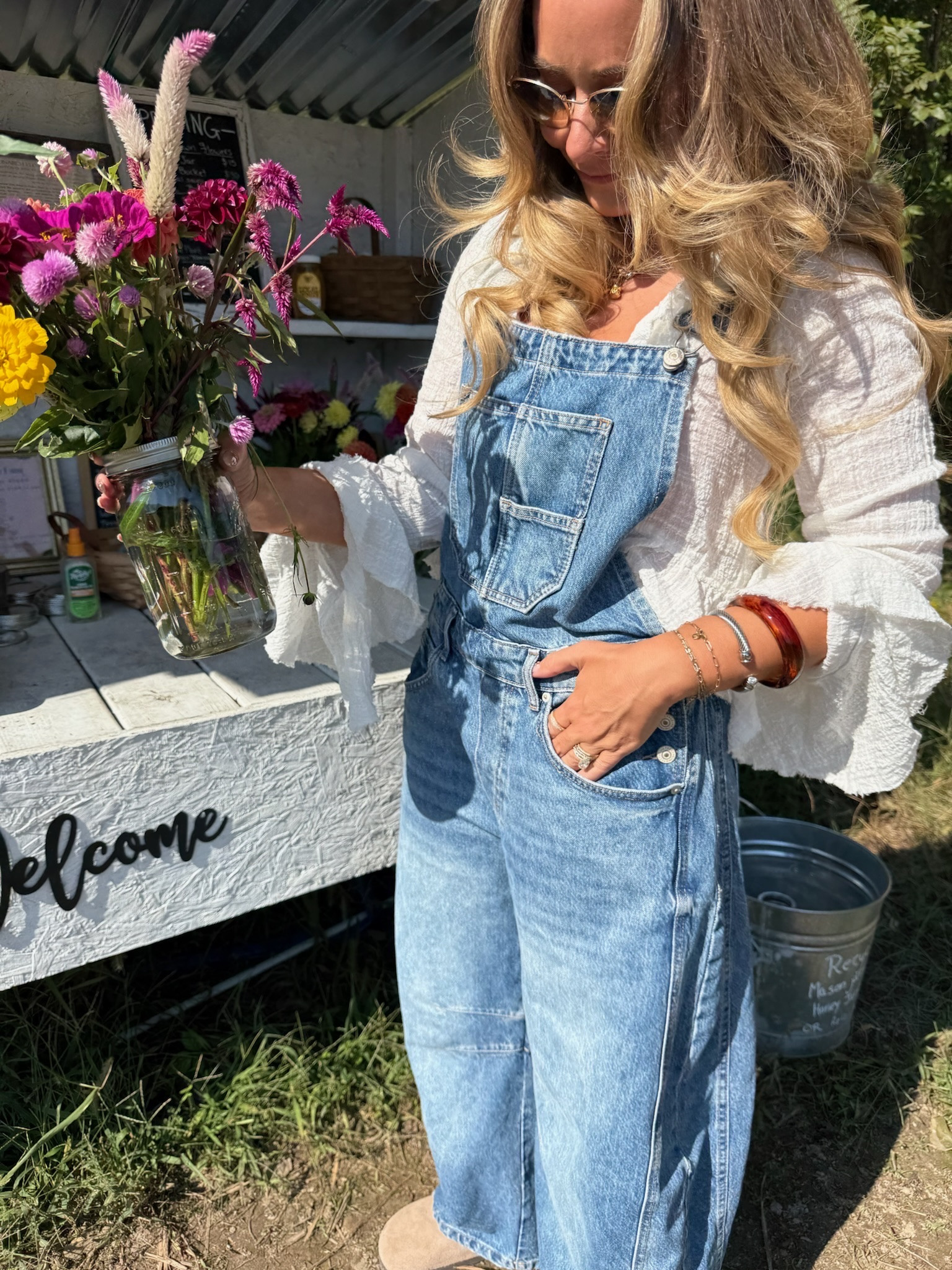 U-pick flower day calls for overalls 🌸 The barrel-leg shape is roomy without swallowing me at 5'2", and the gauzy ruffle-sleeve top underneath makes them feel a little romantic instead of farm chore. Suede clogs keep it comfy for wandering. Overalls: size S · Top: size S

Hashtags: #LTKstyletip #LTKover40 #LTKseasonal #LTKfindsunder100
