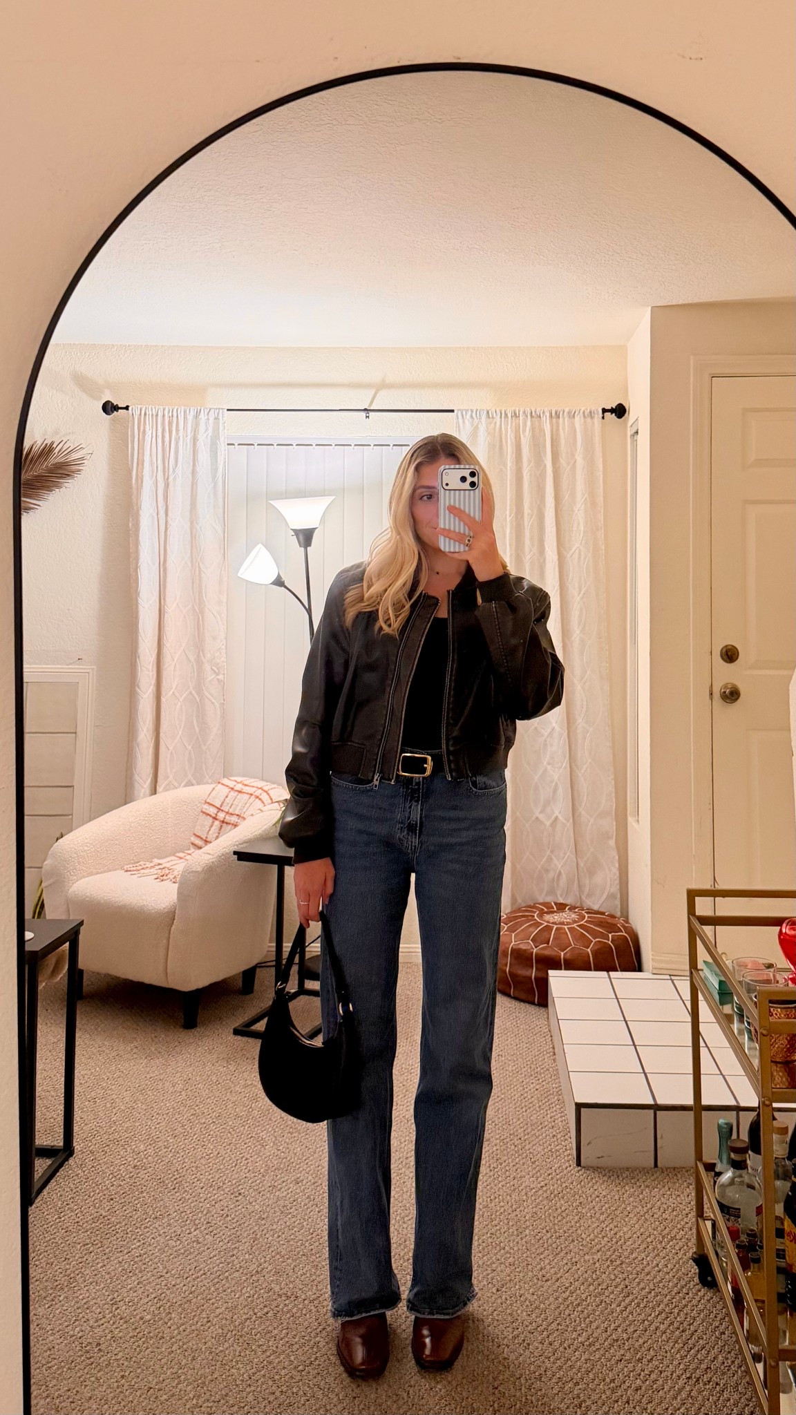 casual winter outfit / leather jacket and jeans styled / red burgundy boots 