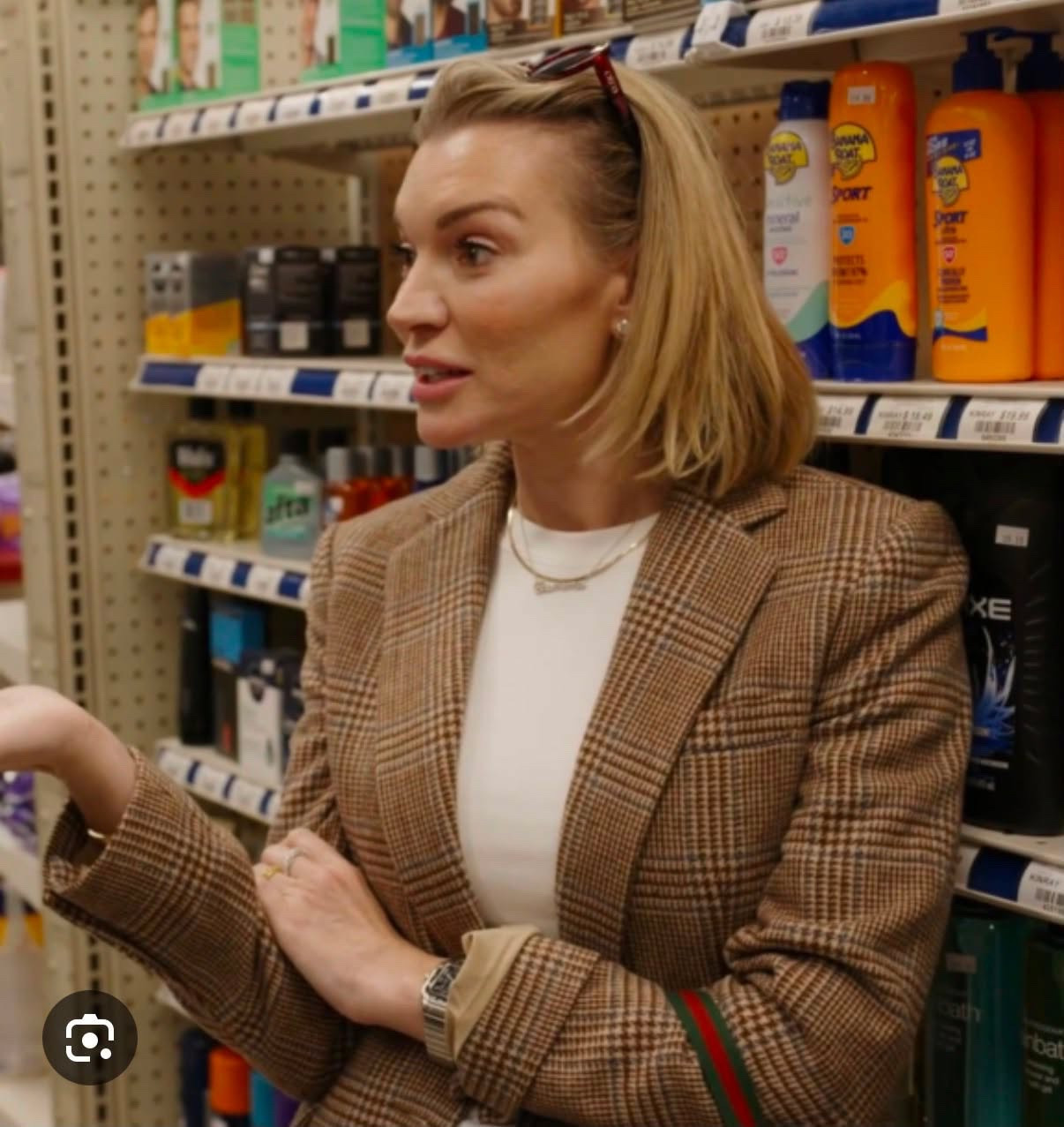 Lindsay Hubbard wearing a double-breasted blazer silhouette. Expertly crafted from an Italian tailoring blend in classic check plaid, it features a slim fit, nipped at the waist for definition. An exaggerated lapel with a low breakpoint completes the look, creating a modern, elongating finish. Style this beige jacket with jeans, ankle boots, and your favorite dickey for a classic VB uniform.