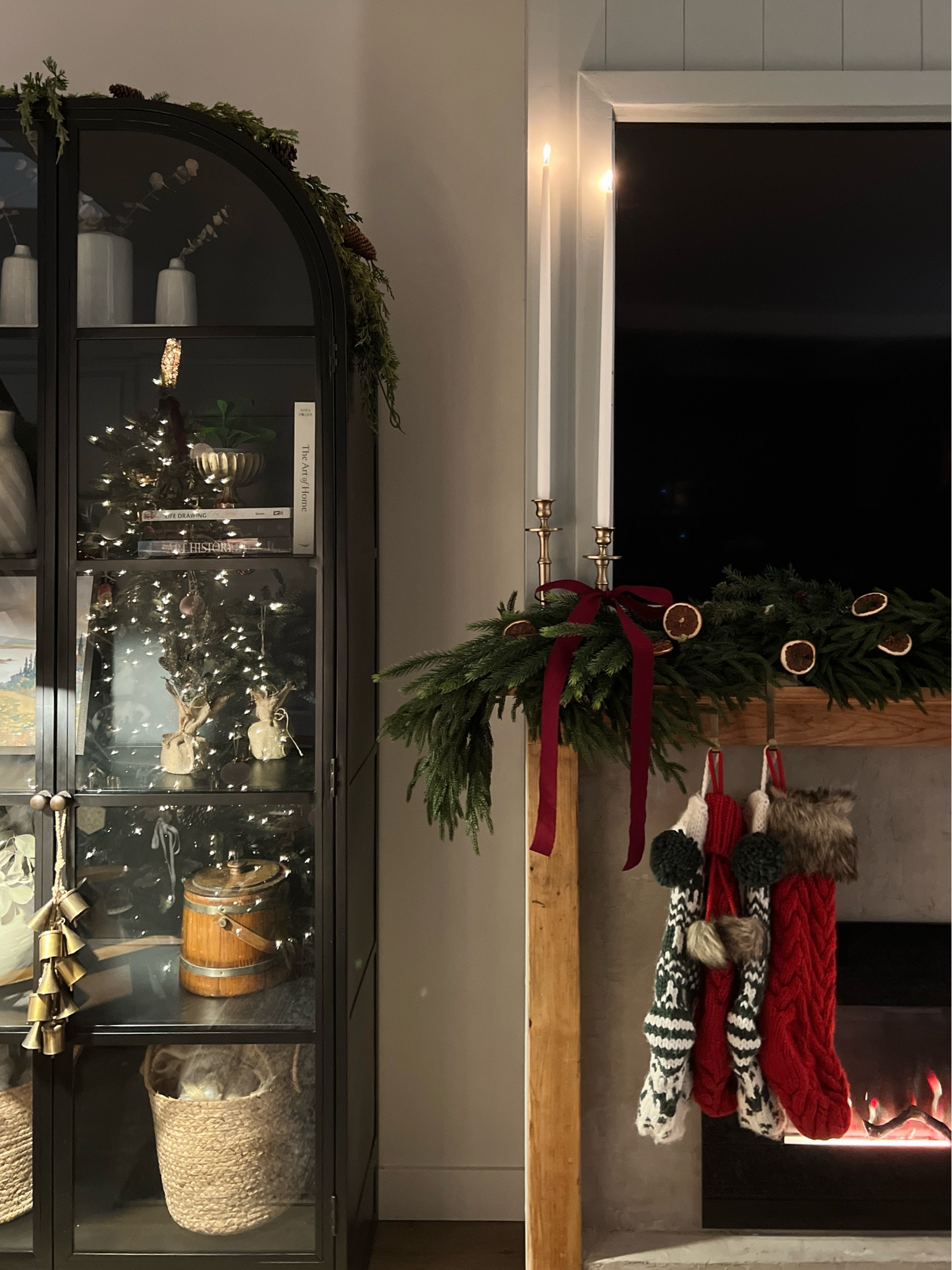 This year’s Christmas mantel is making me so happy! This double-sided red velvet ribbon is the best, and the orange slices with the Norfolk pine garland, the extra tall taper candlesticks, the arched black cabinet, the stockings, the brass bells and candle holders - it’s all coming together. 

This black cabinet is one of our biggest FAQs - and this is one of the best prices I’ve seen in the McGee and Co sale. #LTKCyberWeek

#LTKHoliday #LTKSeasonal
