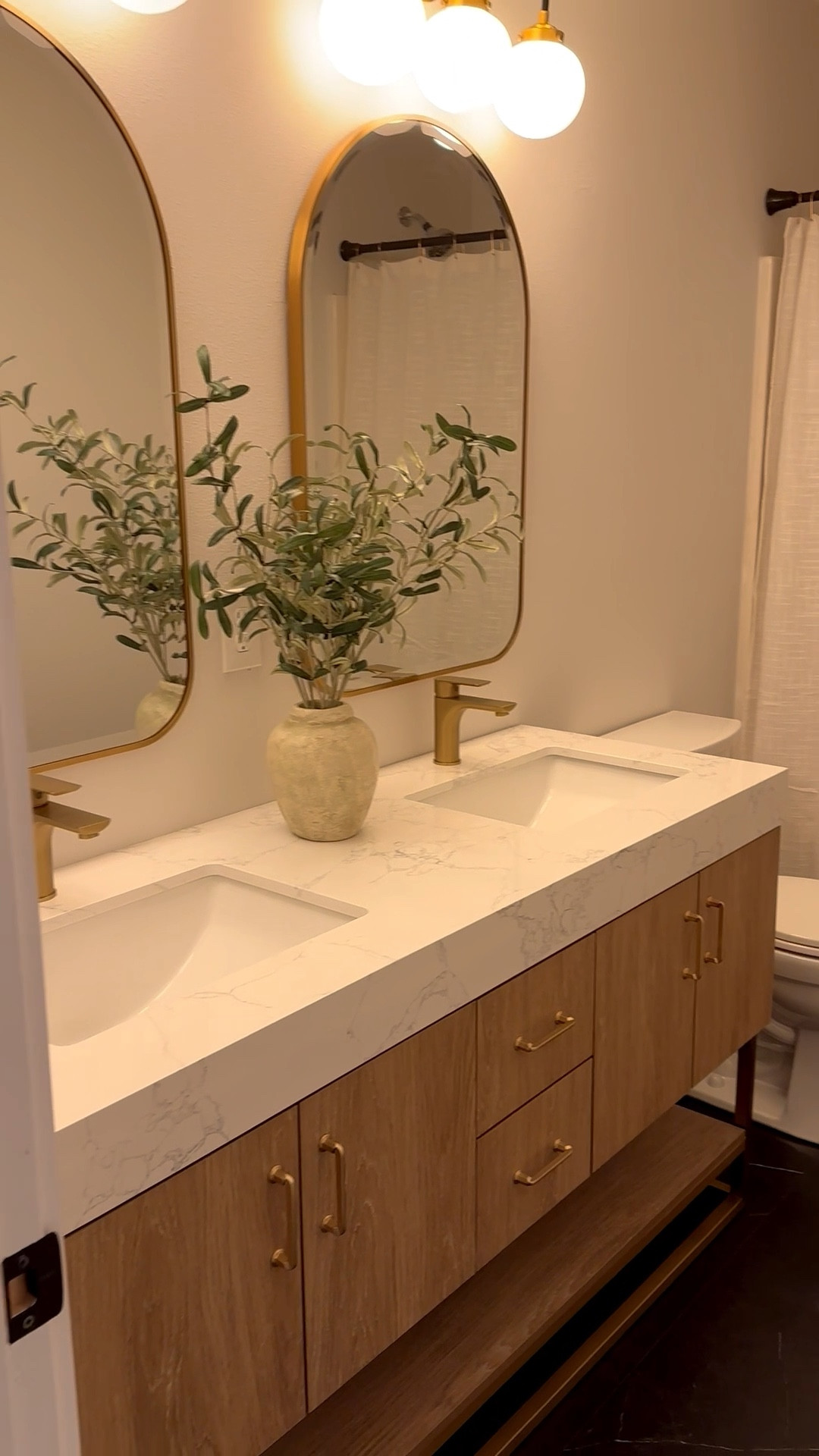 Modern natural wood look double vanity

 Bathroom reno

Alistair 60 in. W x 22 in. D x 33.9 in. H Bath Vanity in Oak with White Stone Vanity Top with Basin

Can’t link but mirrors are from Floor and Decor - Ezra

Black and gold vanity lighting with frosted globes is from Perigold - Jonathan Y Caleb 3 - Light Armed Sconce - also found at Home Depot

White shower curtain from Target  

Modern bathroom, modern vanity, bathroom vanity, bathroom remodel, bathroom inspo 

#LTKSaleAlert #LTKStyleTip #LTKHome