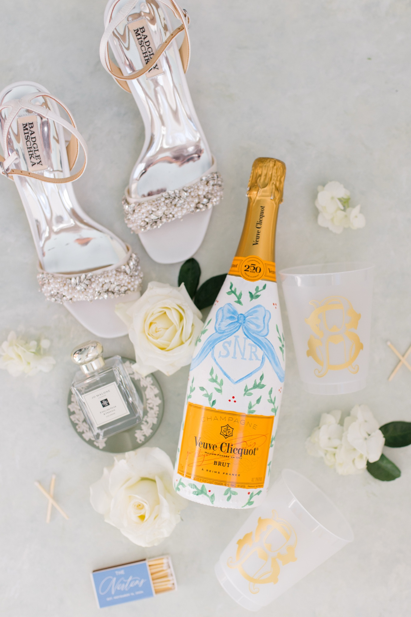 Bridal goodies! 🤍✨🥂
Photographer: Jenna Lindsey

#bride #wedding #bridalshoes #weddingheels #weddingperfume #signaturescent #weddingmatchbook

#LTKWedding #LTKStyleTip #LTKParties
