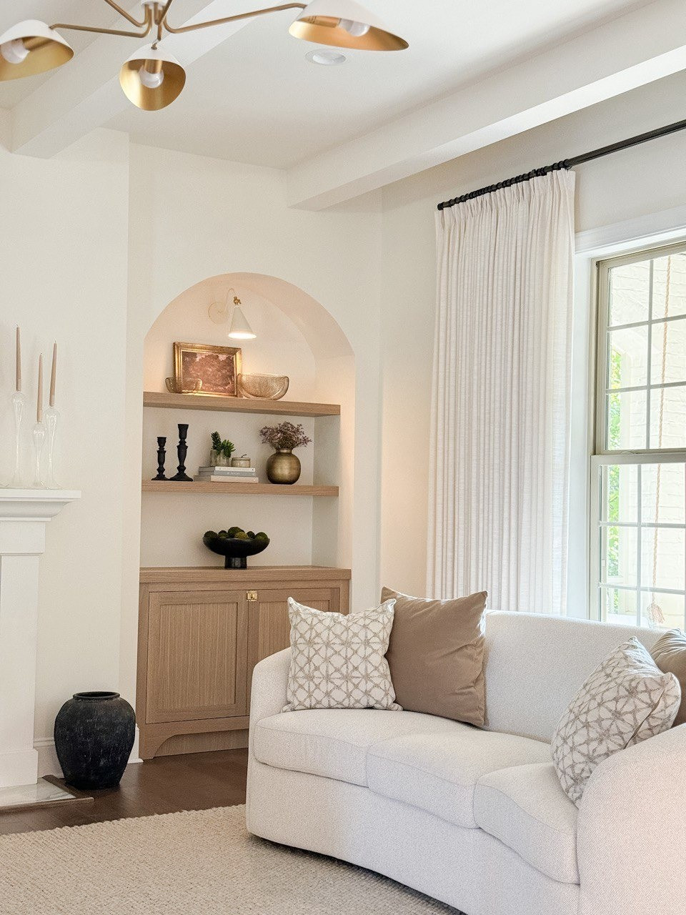 Living Room. Upholstered Sofa, Moss Bolls, Liz Linan Drape Pleated, Ceiling Light, Brass Wire Decorative Bowl, 1 Light Wall Sconce, Cogan Armed Sconce, Area Rug, Moody Trees Framed Wall Canvas Board. 

#LTKHome