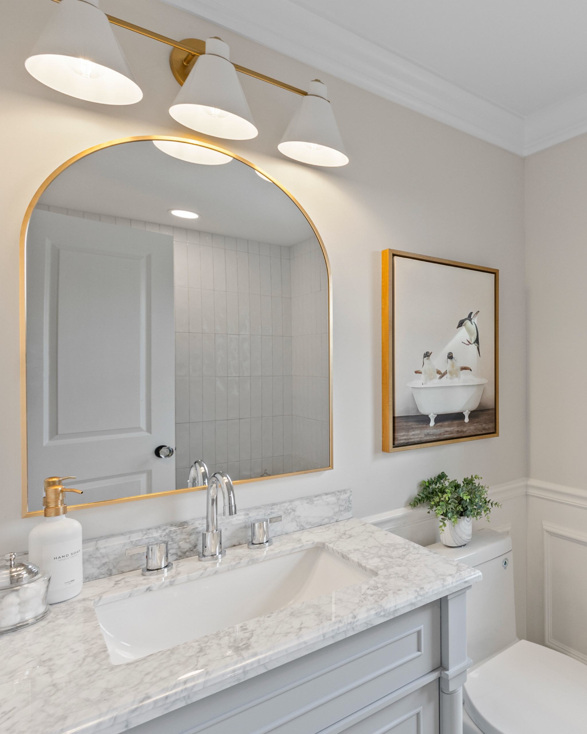 Bathroom Reno at athe Hargrove House is complete! New vanity with marble top and chrome faucet. Warming things up with the addition of brass lighting, mirror and accessories - and one of my favorite whimsical penguin framed art!  A wood bathtub tray to hold the essentials is always a good idea !




#bathroomvanity #plumbingfixtures #deervalley #toilet #archedvanitymirror #vanitylighting

#LTKHome