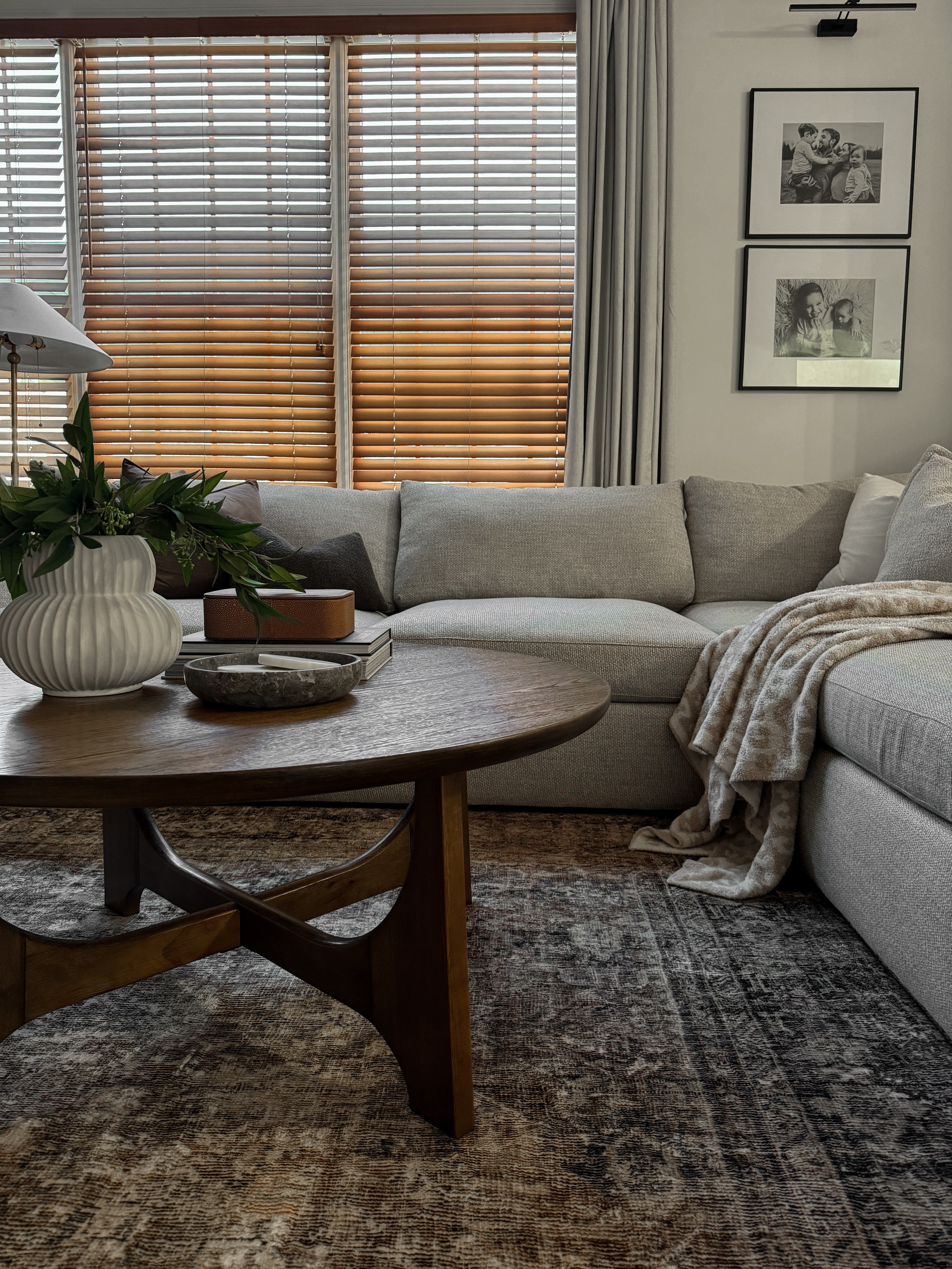 Living room spring decor, Moody living room, sectional couch, lounge deep sofa, round coffee table decor, Wayfair furniture, wall gallery, Moody living room rug, layered rugs, Lolo rug, Amazon rug, coffee table styling

#LTKHome