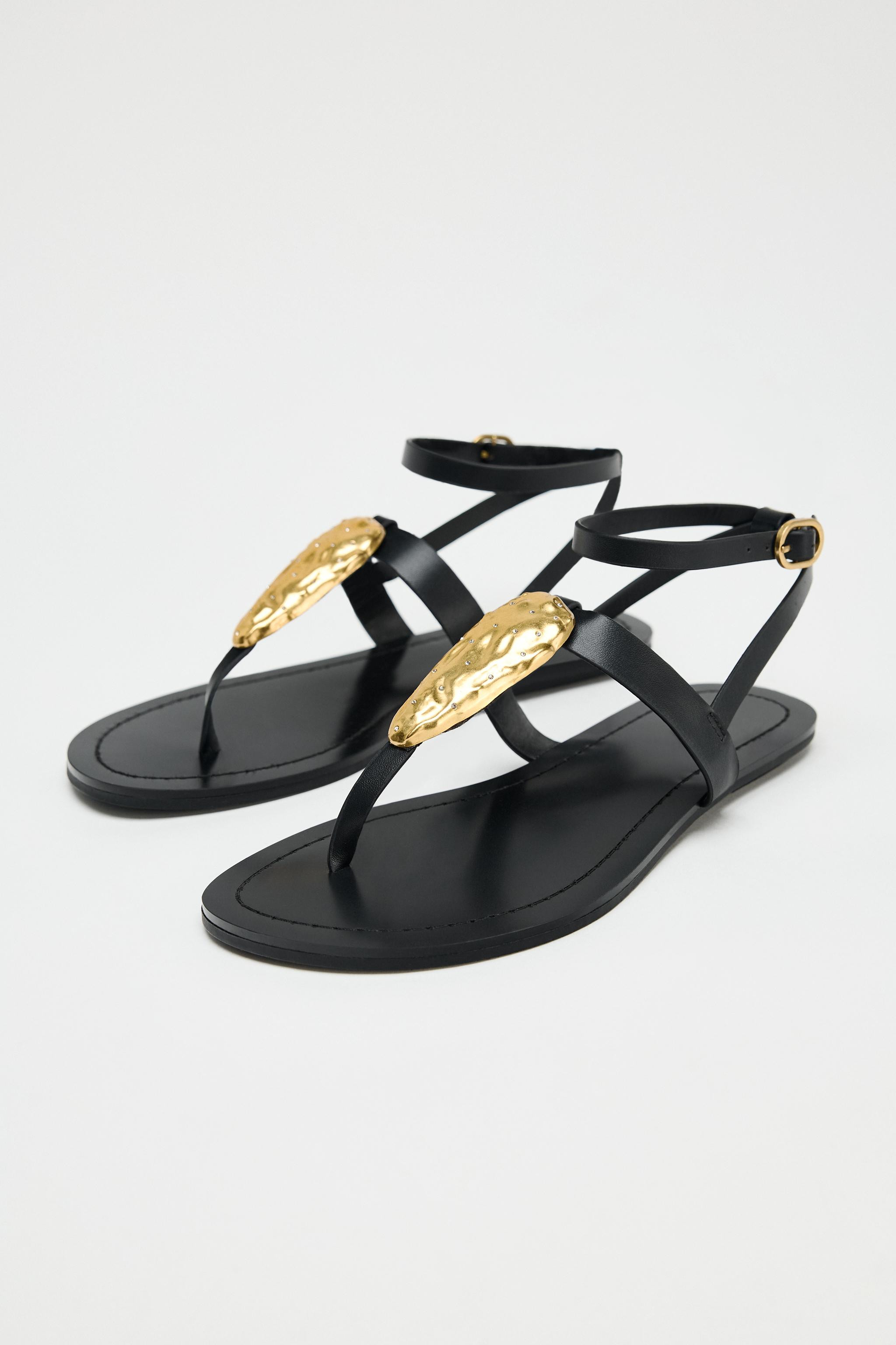 Flat slide sandals with metallic hardware. Toe strap. Ankle strap with metal buckle closure. Roun... | Zara US