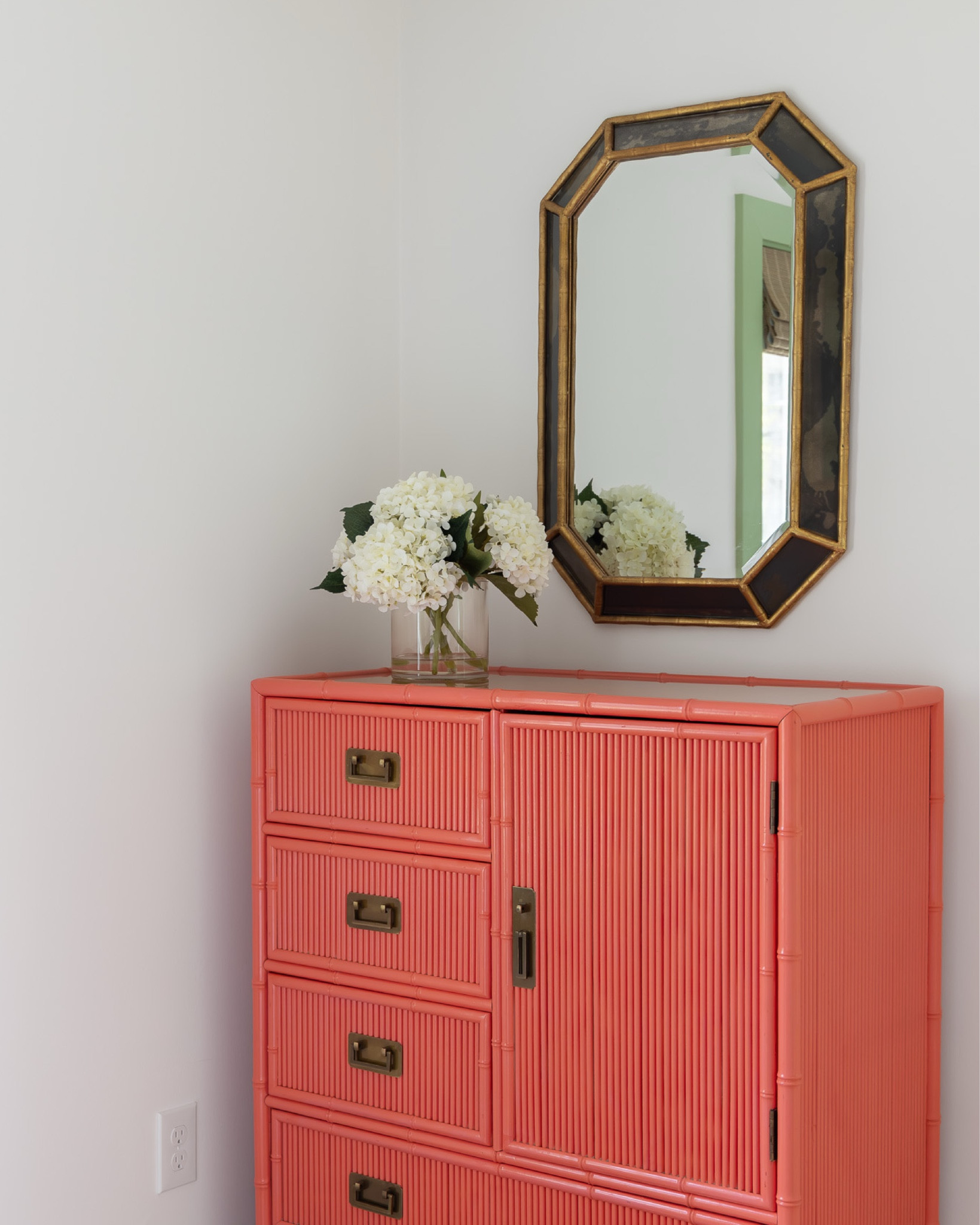 we love this sweet little corner in one of the guest rooms at the #preppyhollowhouse. a coat of coral paint transformed a vintage reeded cabinet into a perfect storage spot for guests. a brass and smoked glass mirror coordinates with the metal pulls on the cabinet and white hydrangeas add a classic Cape Cod touch! #dwelloctoberstay #dwelloctober

#LTKHome