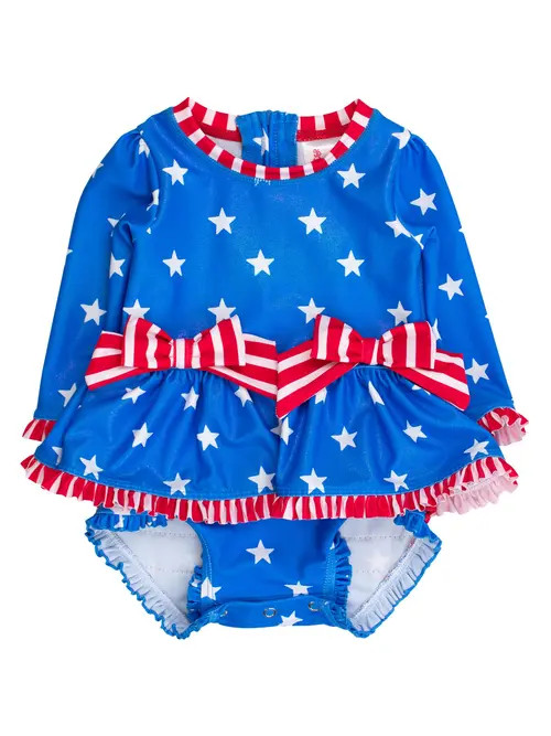 RuffleButts UPF50+ Long Sleeve One Piece Bow Peplum Rash Guard Swimsuit in Shimmer Stars & Stripes at Nordstrom, Size 18-24M | Nordstrom