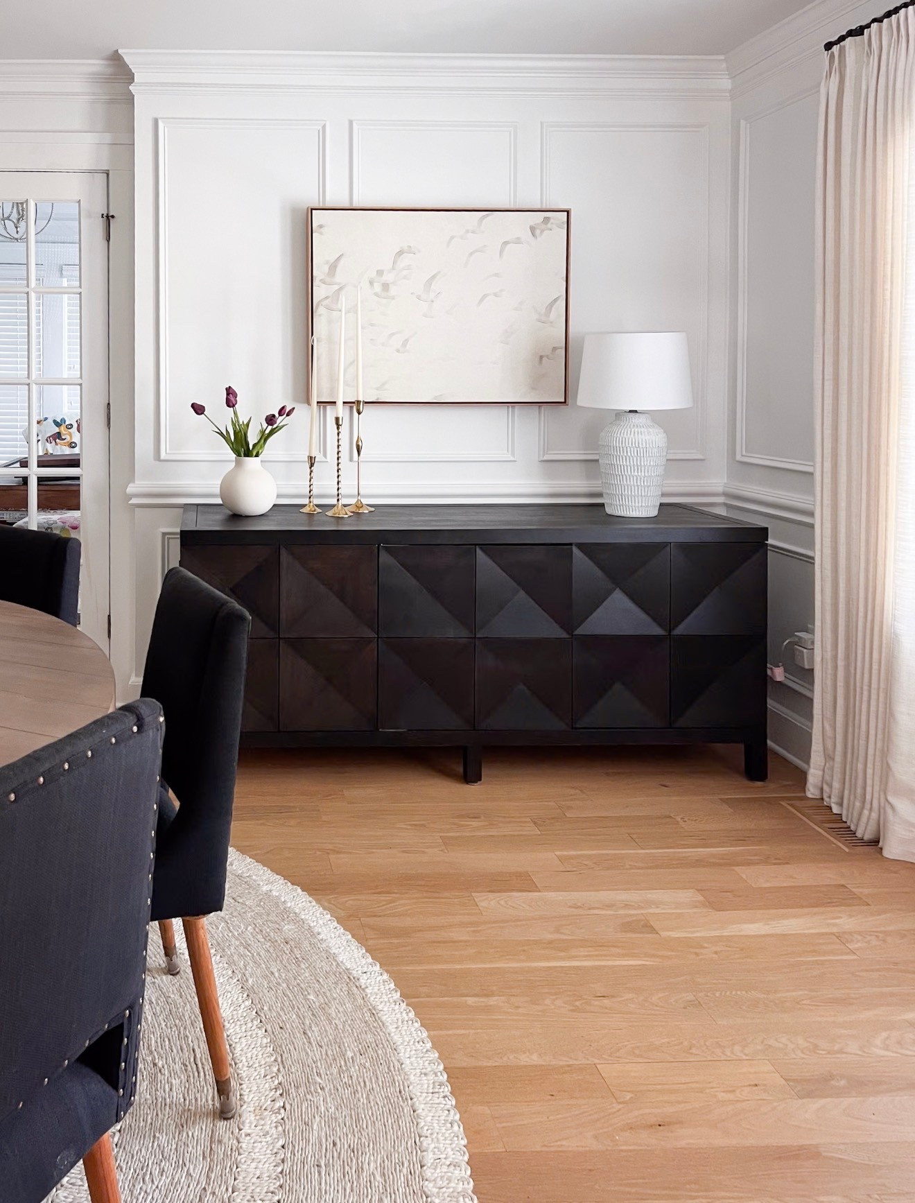 Love this modern coastal dining room that I helped with! The prettiest natural fiber rug grounds the room and pops of black keep it neutral but still interesting. You might recognize this framed canvas from my own home (I own it too!) 

Neutral dining room, dining room console, spring entertaining, spring decor, spring dining room, tulips, neutral art, Serena & Lily rug, Lily & Georgia 

#LTKHome #LTKSeasonal #LTKdayinmylife