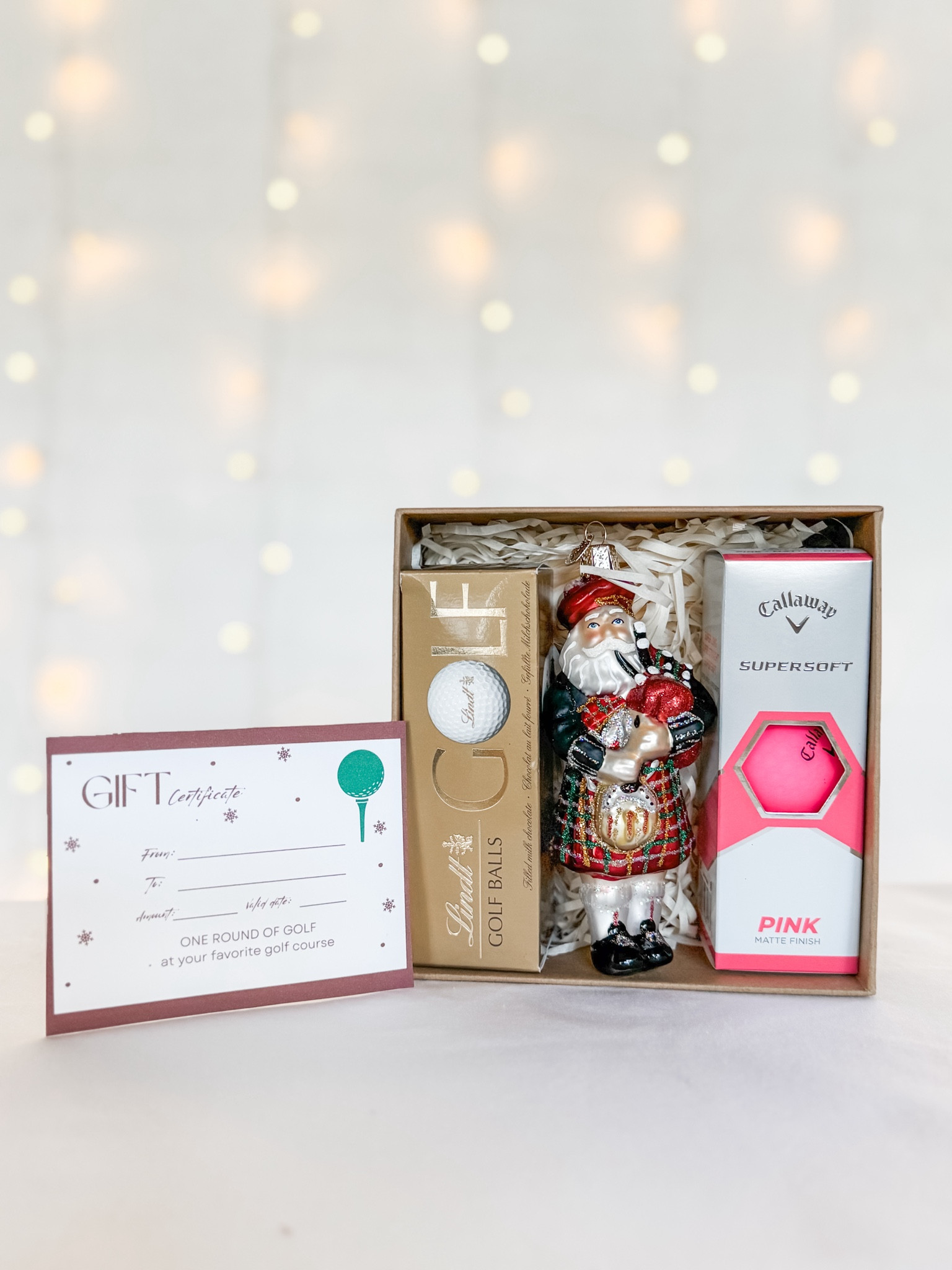 Golf Christmas Gift! Gift your favorite golfer a gift certificate for a round at his/her favorite golf course along with chocolate Lindor Lindt golf balls, a glass Santa golfer ornament, & a sleeve of his/her favorite golf balls. Mine are these pink Callaway super soft golf balls! I like gifting in these reusable brown craft boxes with a pretty bow.

#LTKSeasonal #LTKxPrimeDay #LTKMens