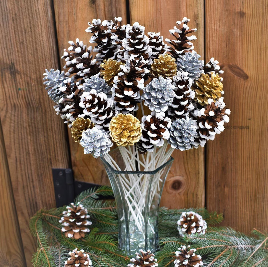 These handcrafted pinecone flowers are a stunning way to bring winter sparkle into your home décor. Each dozen includes a beautiful mix of silver, gold, and snow-tipped pinecones, all carefully collected, baked, painted, and finished by hand on white wooden stems. The touch of holographic glitter and frosted detail gives them a magical, snow-kissed look that works perfectly styled in a vase or mixed into winter arrangements. Long-lasting and full of rustic charm, they make an eye-catching centerpiece for seasonal gatherings and winter celebrations.

#LTKhome #LTKseasonal #WinterDecor #PineconeDecor #HandmadeHome #EtsyFinds #HolidayCenterpiece #RusticWinter #HomeStyling

#LTKSeasonal #LTKHoliday #LTKHome
